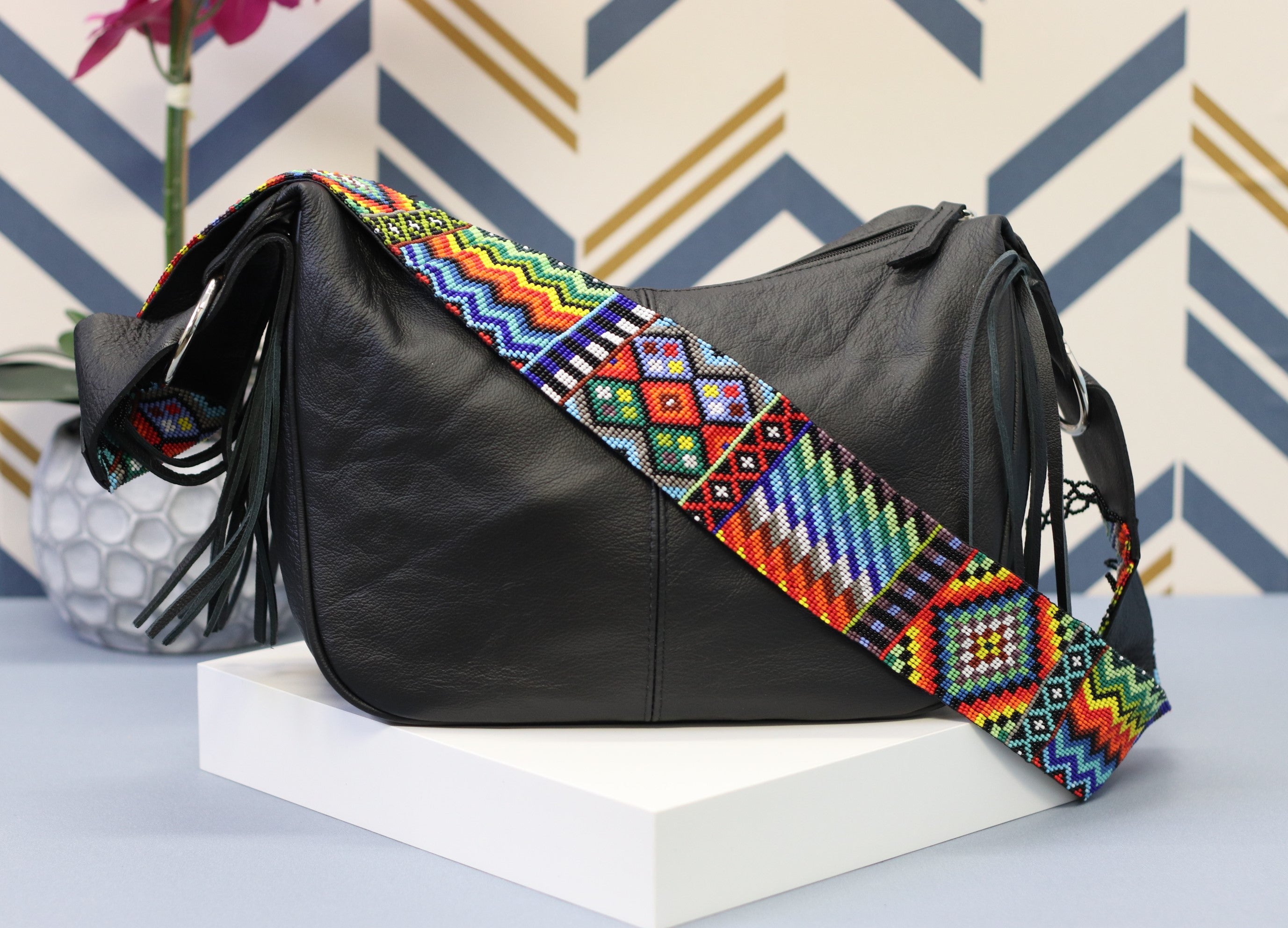 Black Leather Messenger Bag with Hand Beaded Seed Bead Shoulder Strap. Handmade, Fast Shipping. Hand Beaded Shoulder Strap Multicolor. Cowhide Leather with Seed Bead Accent. Buy now at www.felipeandgrace.com