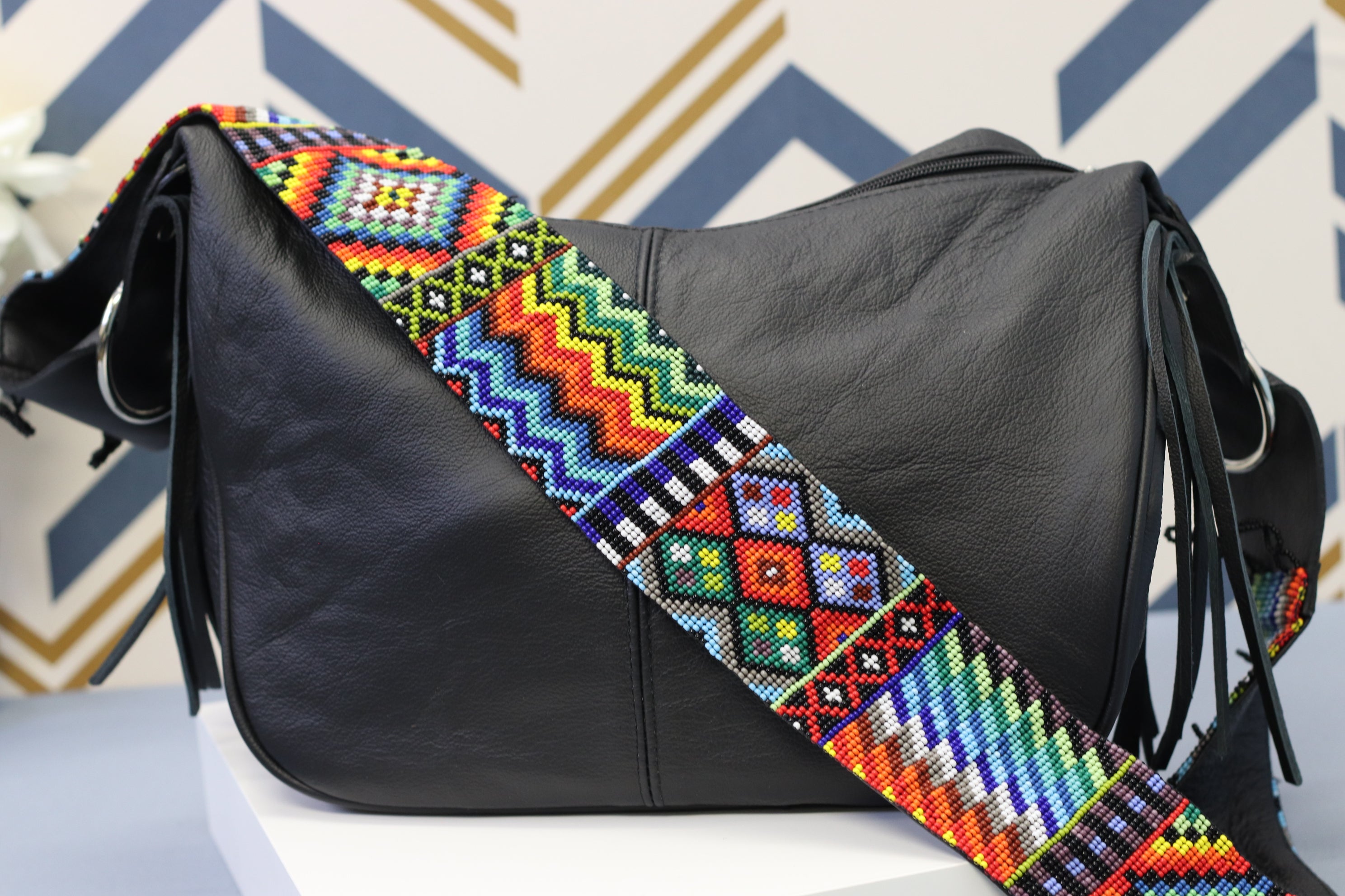 Black Leather Messenger Bag with Hand Beaded Seed Bead Shoulder Strap. Handmade, Fast Shipping. Hand Beaded Shoulder Strap Multicolor. Cowhide Leather with Seed Bead Accent. Buy now at www.felipeandgrace.com