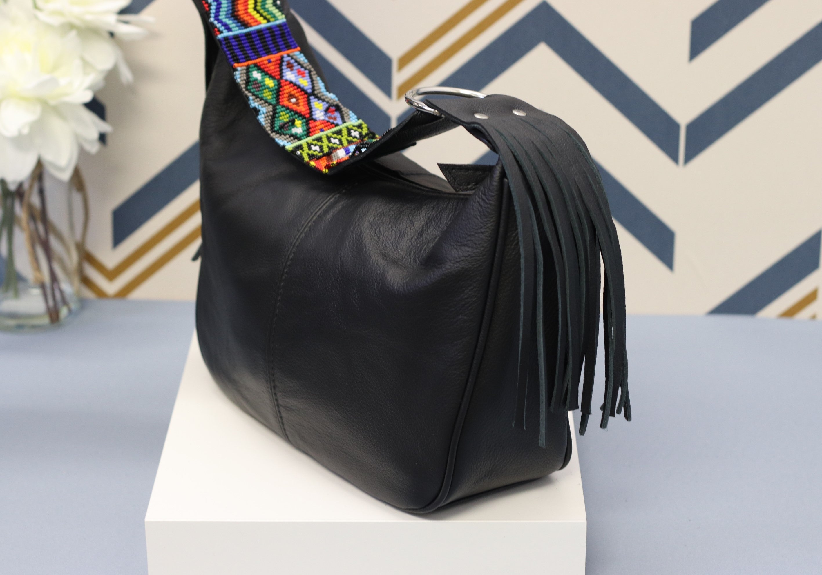 Black Leather Messenger Bag with Hand Beaded Seed Bead Shoulder Strap. Handmade, Fast Shipping. Hand Beaded Shoulder Strap Multicolor. Cowhide Leather with Seed Bead Accent. Buy now at www.felipeandgrace.com