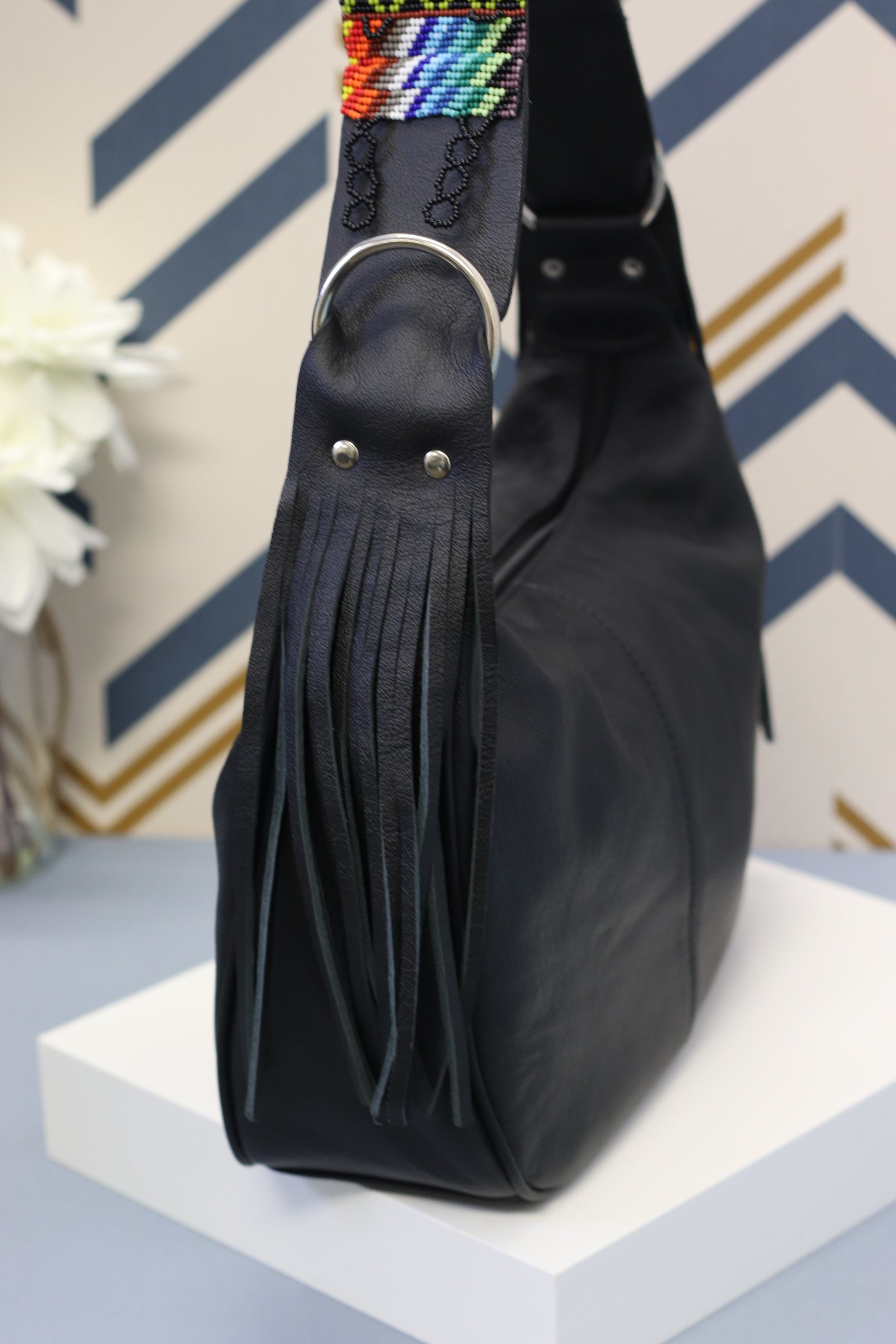 Black Leather Messenger Bag with Hand Beaded Seed Bead Shoulder Strap. Handmade, Fast Shipping. Hand Beaded Shoulder Strap Multicolor. Cowhide Leather with Seed Bead Accent. Buy now at www.felipeandgrace.com