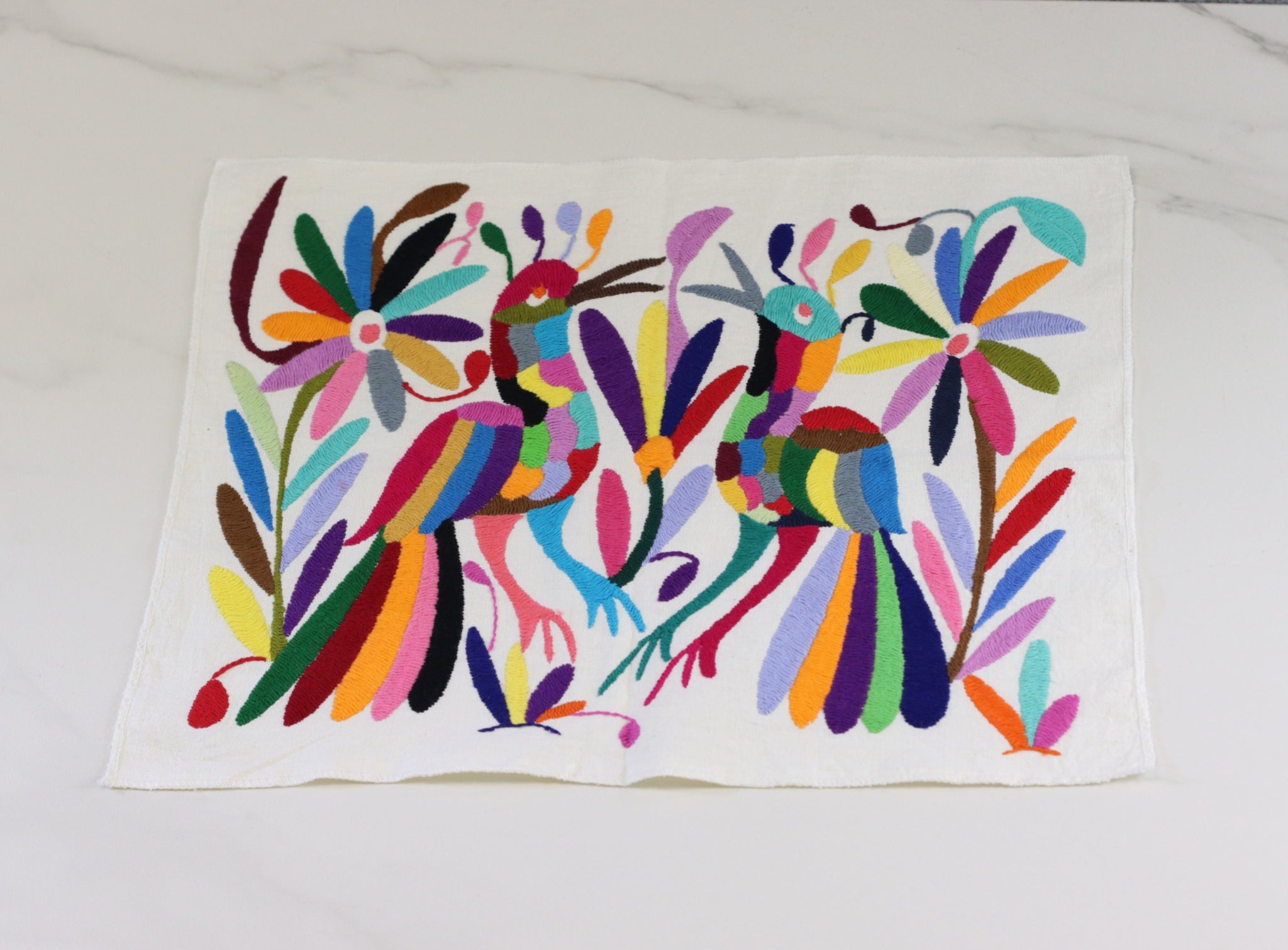 Otomi Tenango Placemat or Frameable Art Handmade with Embroidered Birds, Flowers, and Animals in Vibrant Colors. Handmade in Mexico. Ships from the USA. Buy now at www.felipeandgrace.com.
