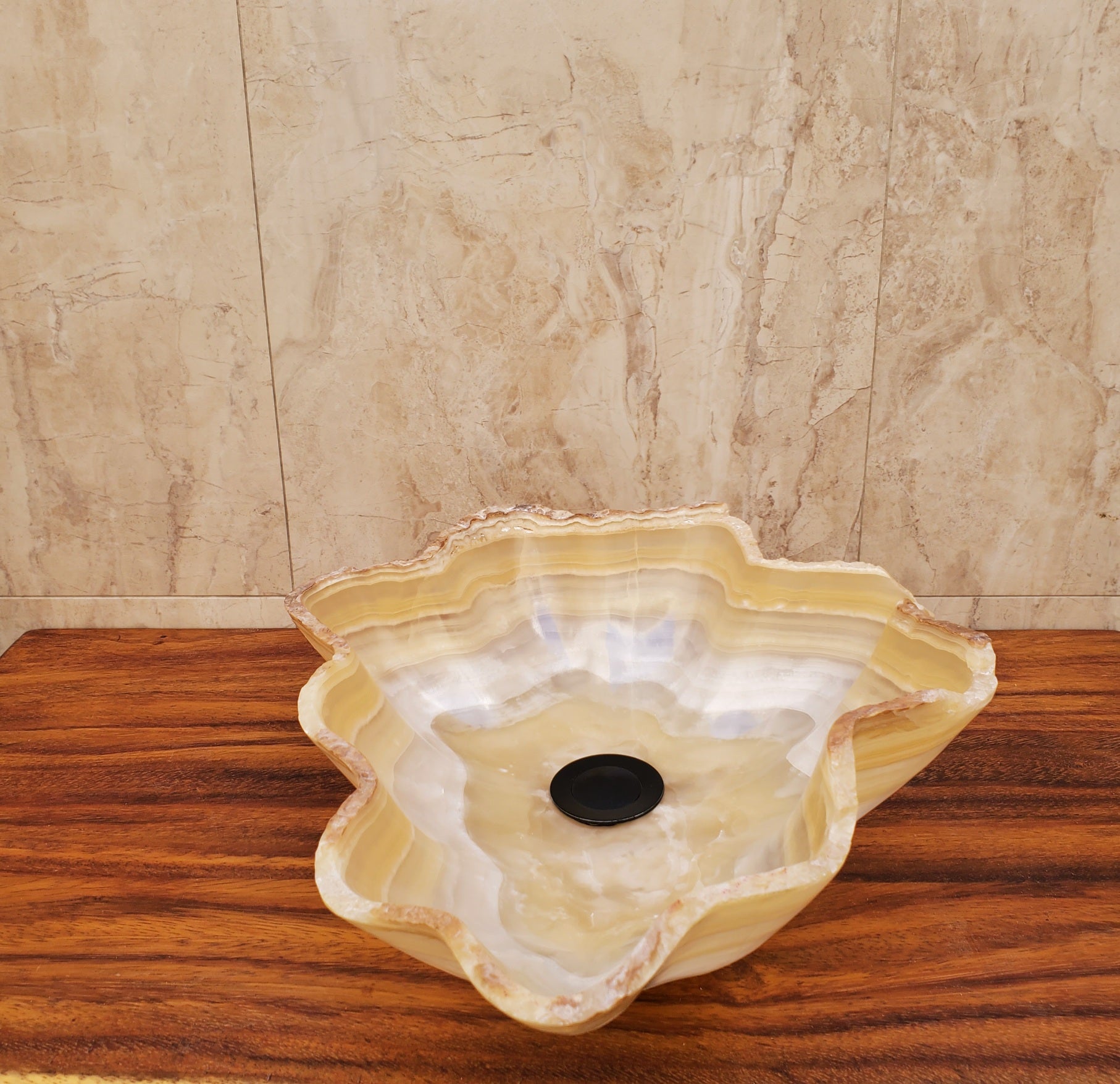 Beige and White Onyx Oyster Shell Shaped Vessel Sink. Handmade in Mexico. We hand finish and ship from the USA. Buy now at www.felipeandgrace.com.