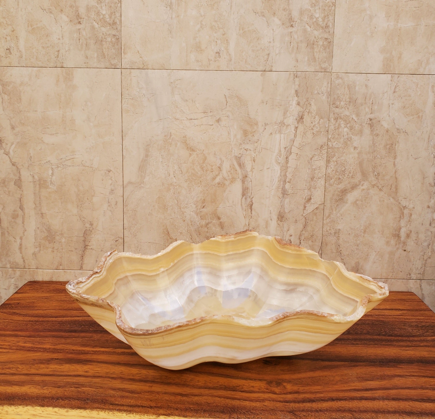 Beige and White Onyx Oyster Shell Shaped Vessel Sink. Handmade in Mexico. We hand finish and ship from the USA. Buy now at www.felipeandgrace.com.