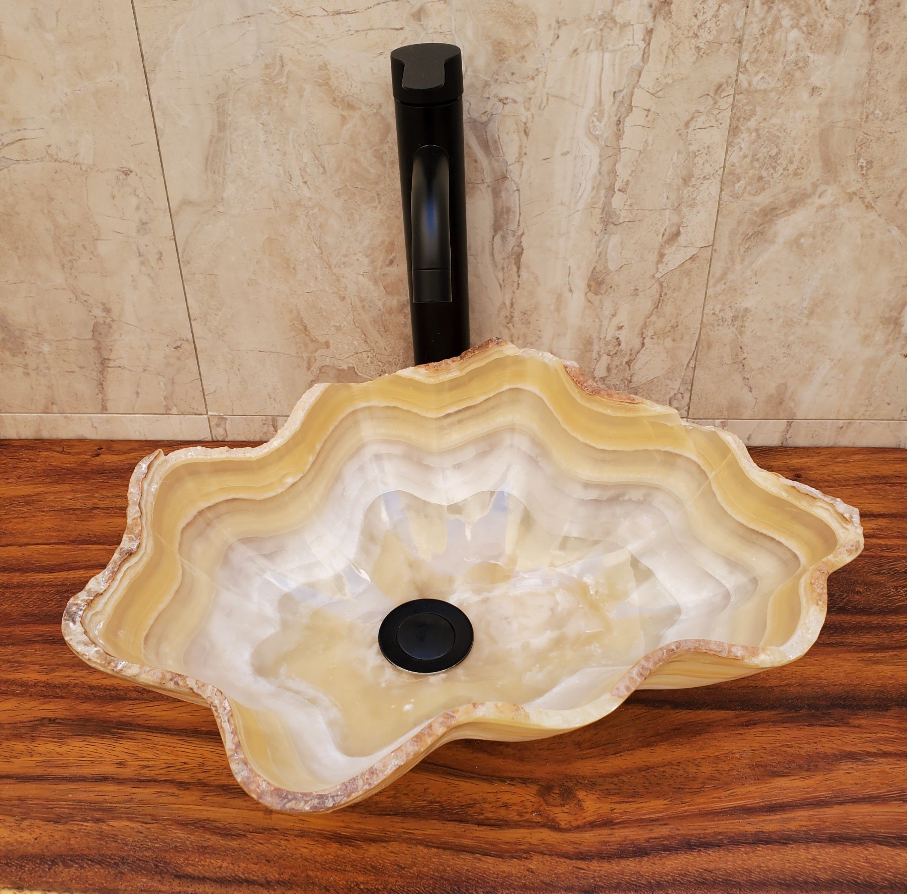 Beige and White Onyx Oyster Shell Shaped Vessel Sink. Handmade in Mexico. We hand finish and ship from the USA. Buy now at www.felipeandgrace.com.