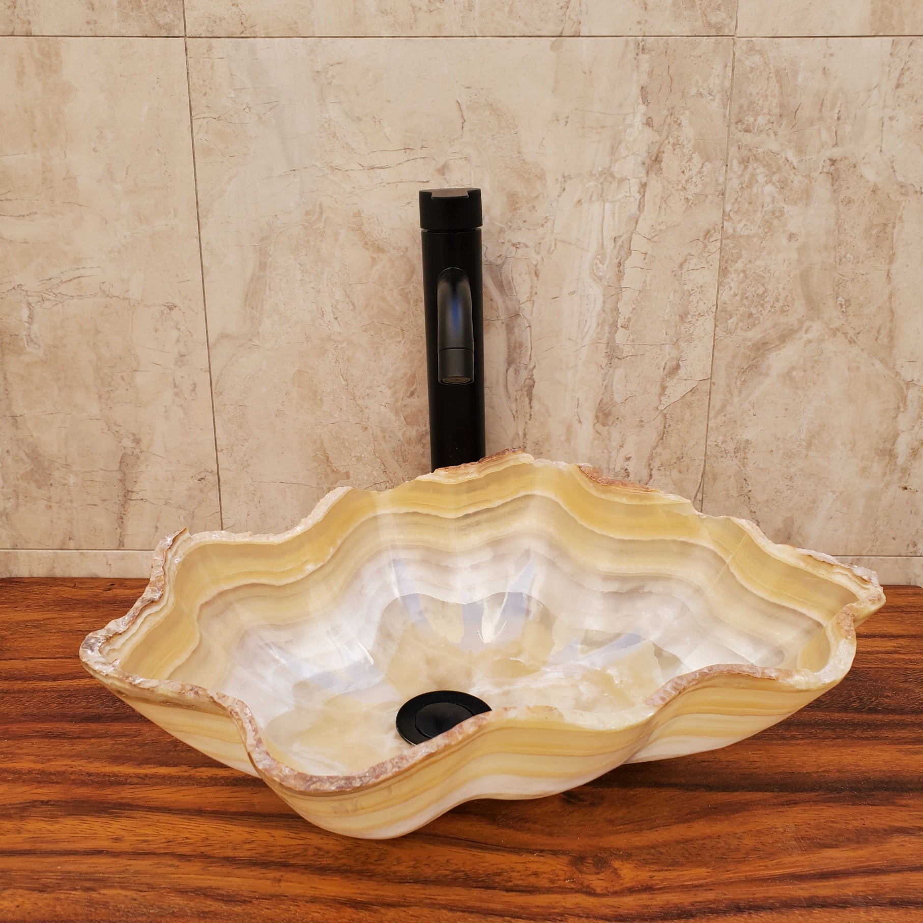 Beige and White Onyx Oyster Shell Shaped Vessel Sink. Handmade in Mexico. We hand finish and ship from the USA. Buy now at www.felipeandgrace.com.