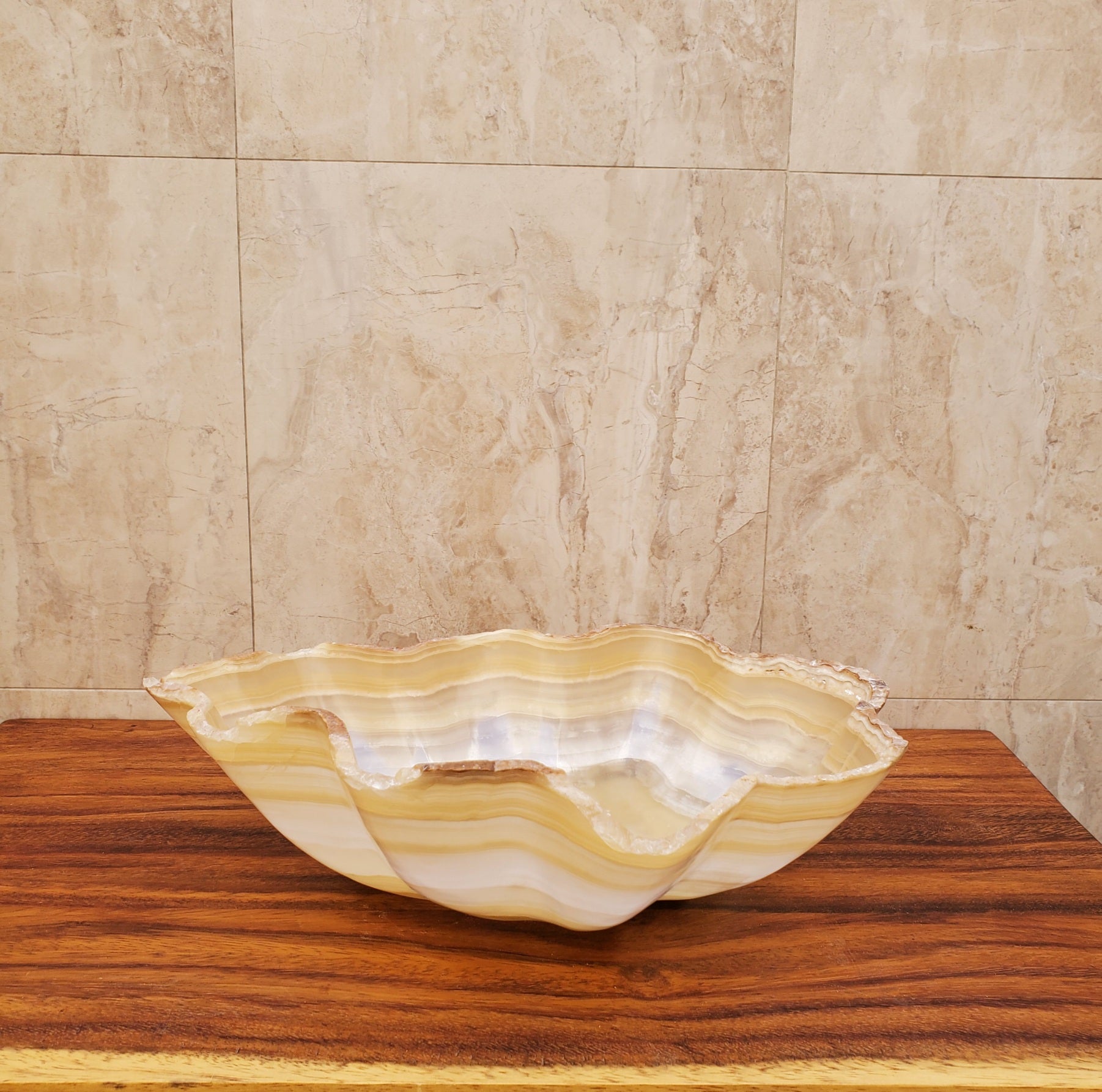Beige and White Onyx Oyster Shell Shaped Vessel Sink. Handmade in Mexico. We hand finish and ship from the USA. Buy now at www.felipeandgrace.com.