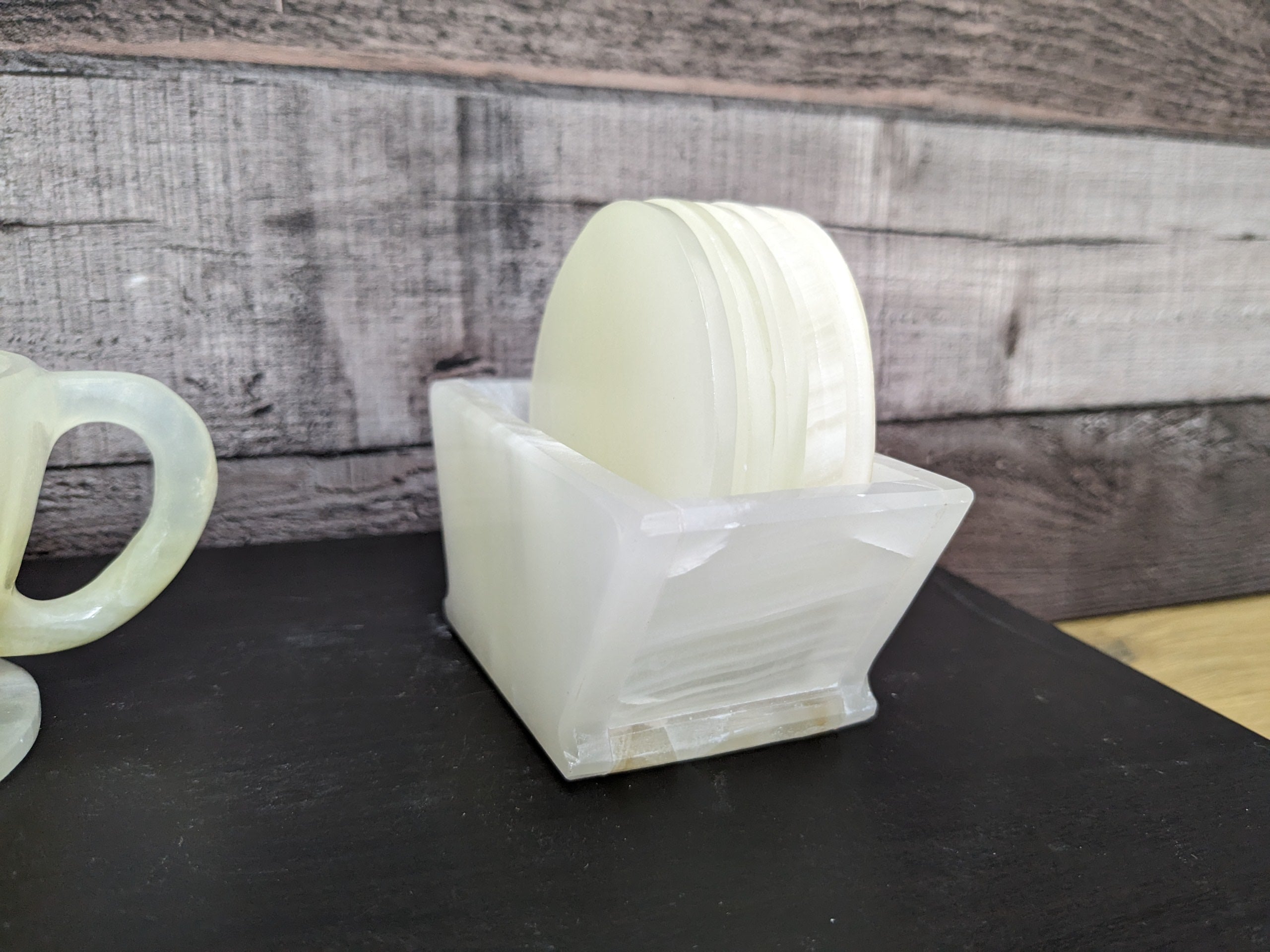 White Onyx Coaster Set of Six with Holder. The coasters are round. Handmade in Mexico. Ships from the USA. Buy now at www.felipeandgrace.com.