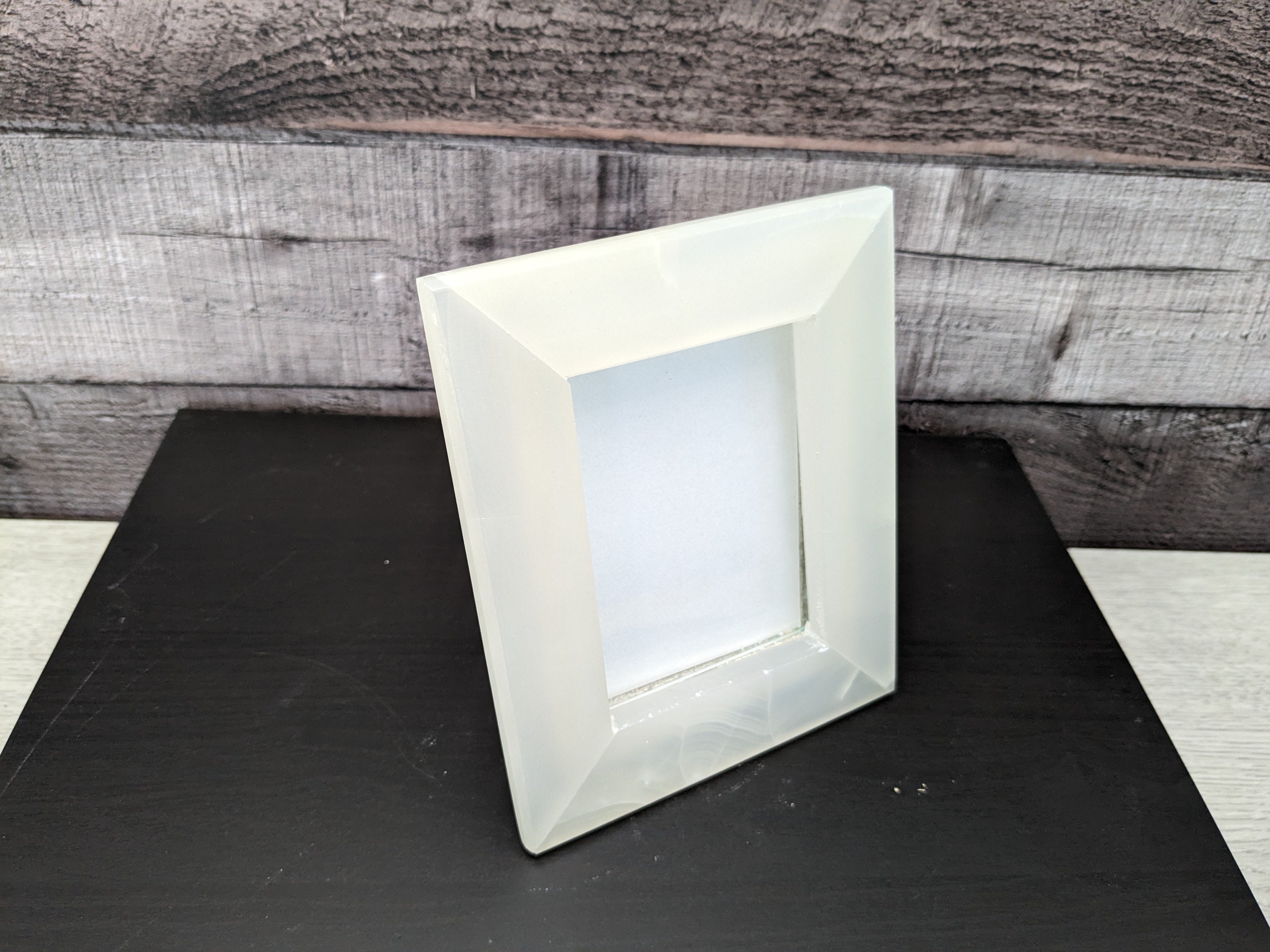 White Onyx Frame with Glass Covering and Travertine Stone Stand. Handmade in Mexico. We package and ship from the USA. Buy now at www.felipeandgrace.com.