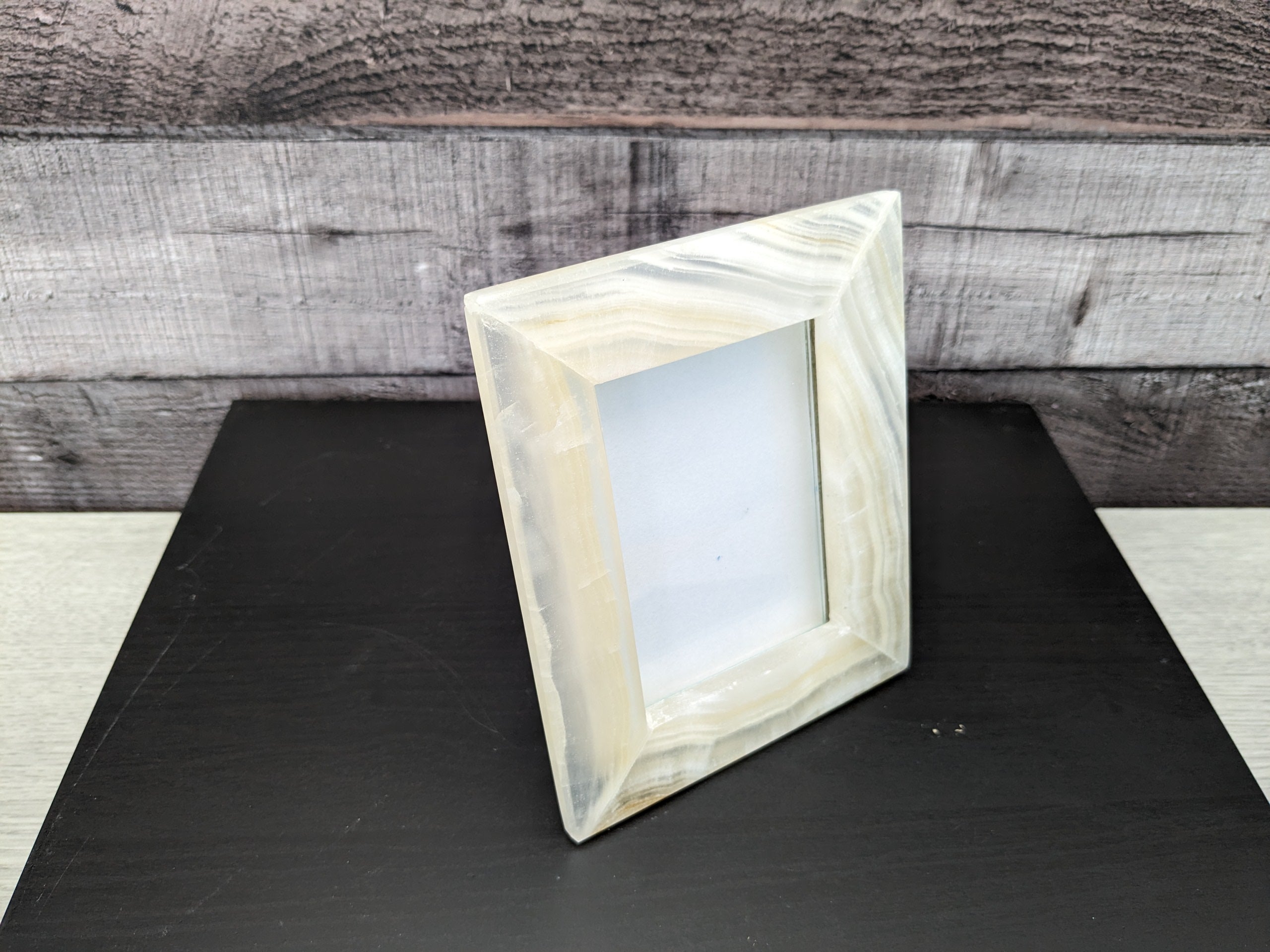 White Onyx Frame with Glass Covering and Travertine Stone Stand. Handmade in Mexico. We package and ship from the USA. Buy now at www.felipeandgrace.com.