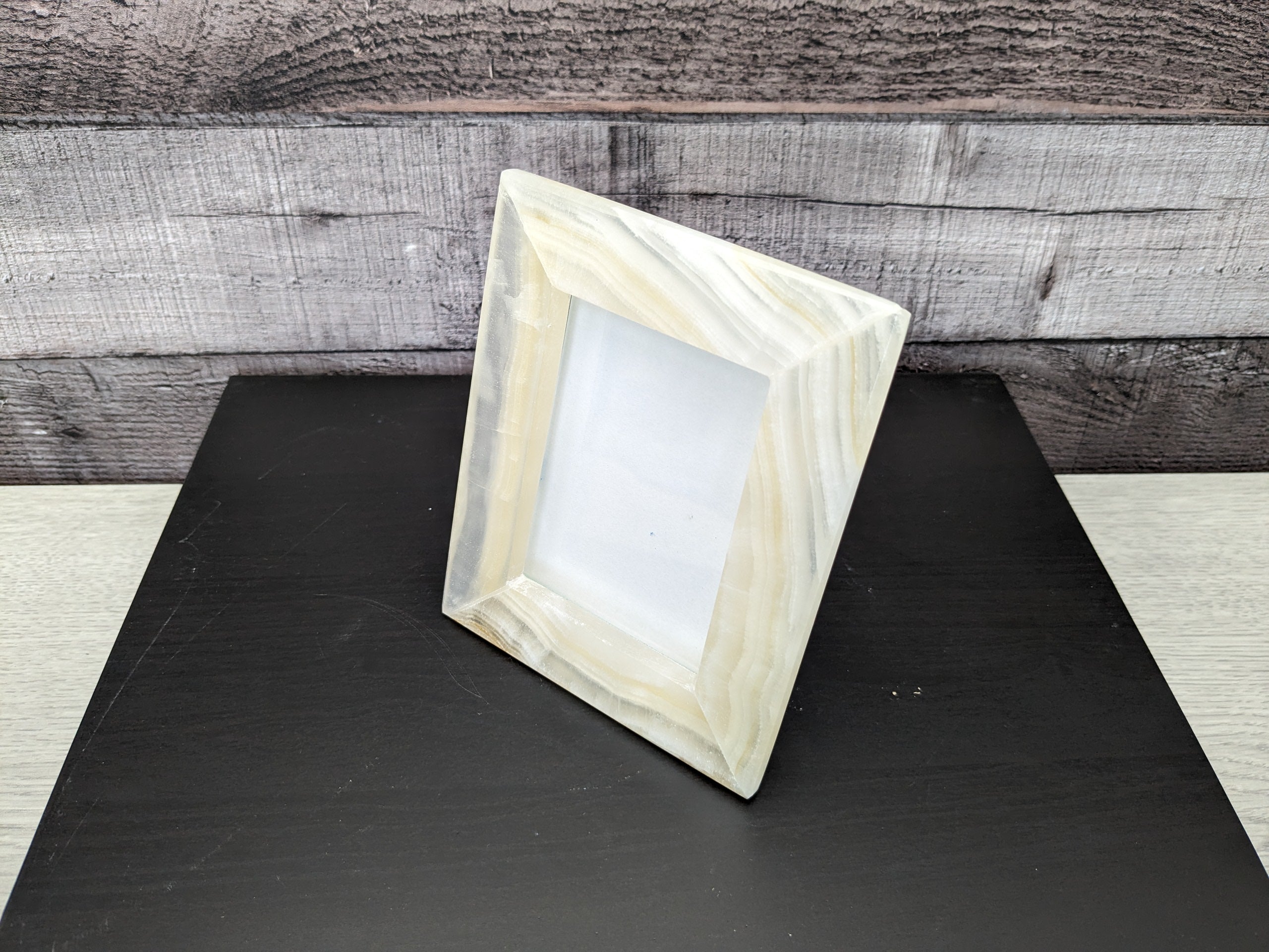 White Onyx Frame with Glass Covering and Travertine Stone Stand. Handmade in Mexico. We package and ship from the USA. Buy now at www.felipeandgrace.com.