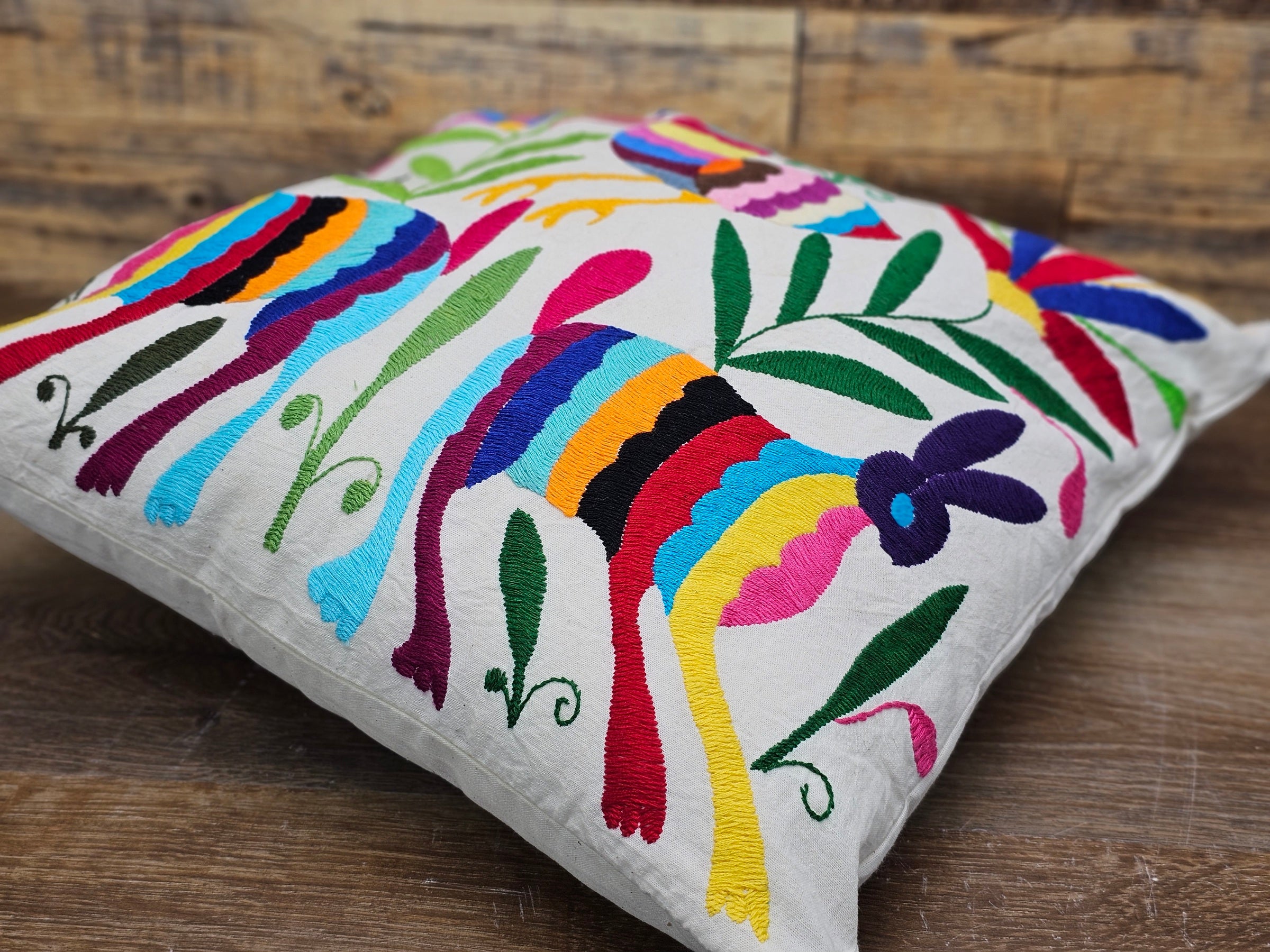Square Otomi Tenango Pillow Cover with Hand Embroidered Birds, Flowers, and Animals in Vibrant Colors. Handmade in Mexico. Ships from the USA. Buy now at www.felipeandgrace.com.
