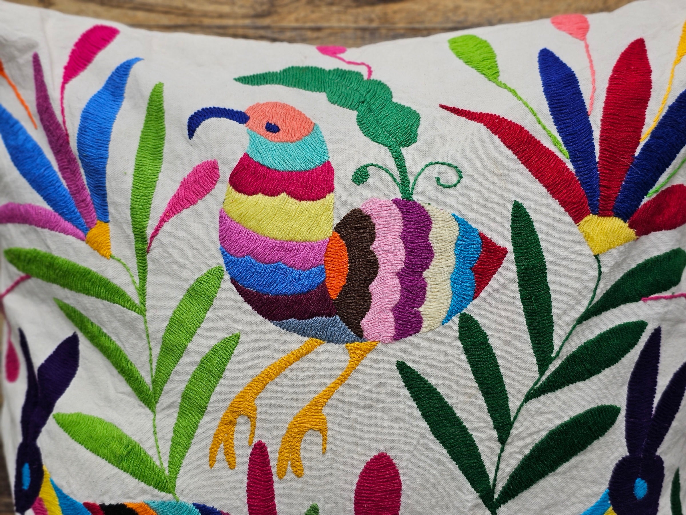Square Otomi Tenango Pillow Cover with Hand Embroidered Birds, Flowers, and Animals in Vibrant Colors. Handmade in Mexico. Ships from the USA. Buy now at www.felipeandgrace.com.