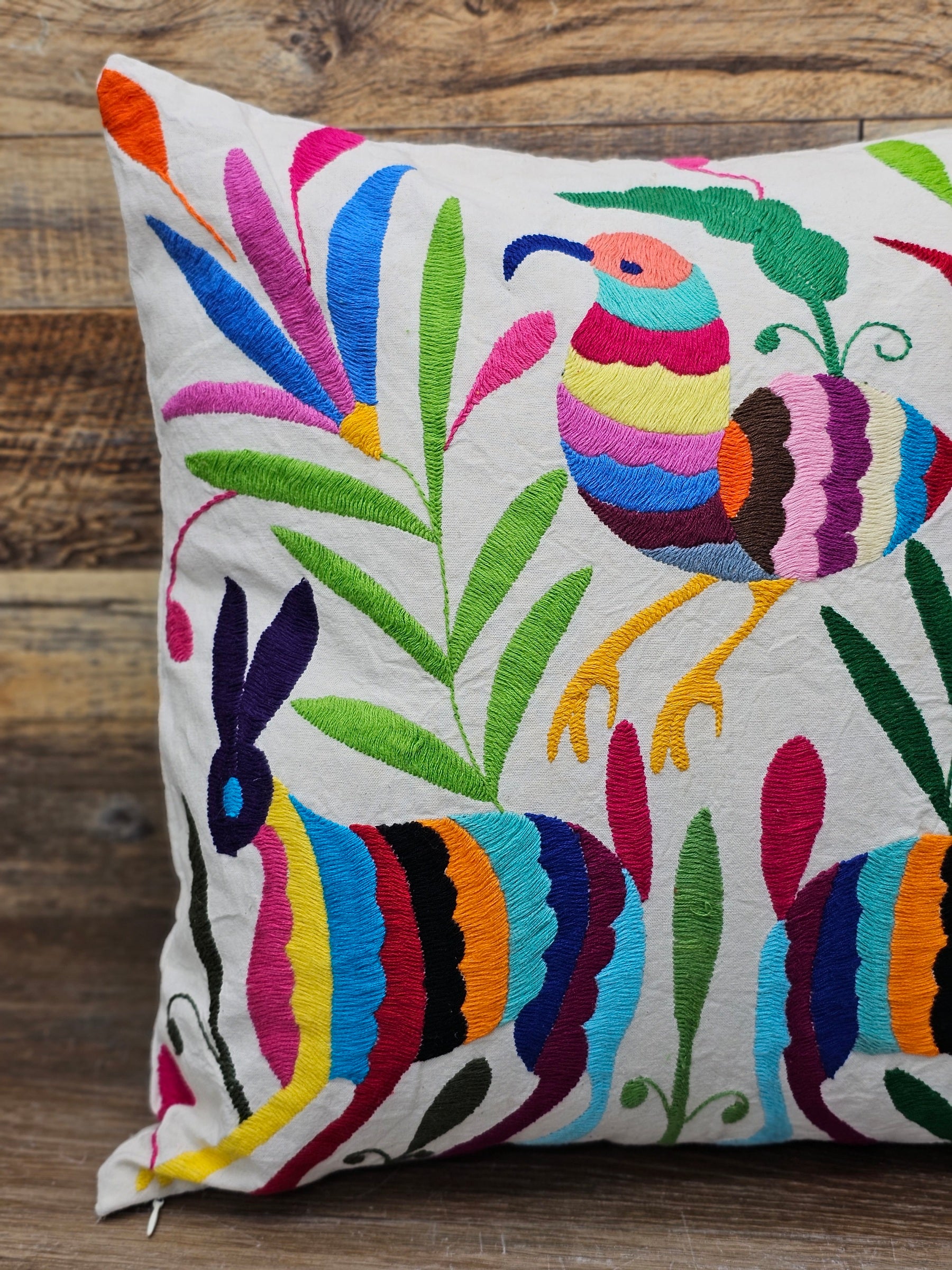 Square Otomi Tenango Pillow Cover with Hand Embroidered Birds, Flowers, and Animals in Vibrant Colors. Handmade in Mexico. Ships from the USA. Buy now at www.felipeandgrace.com.