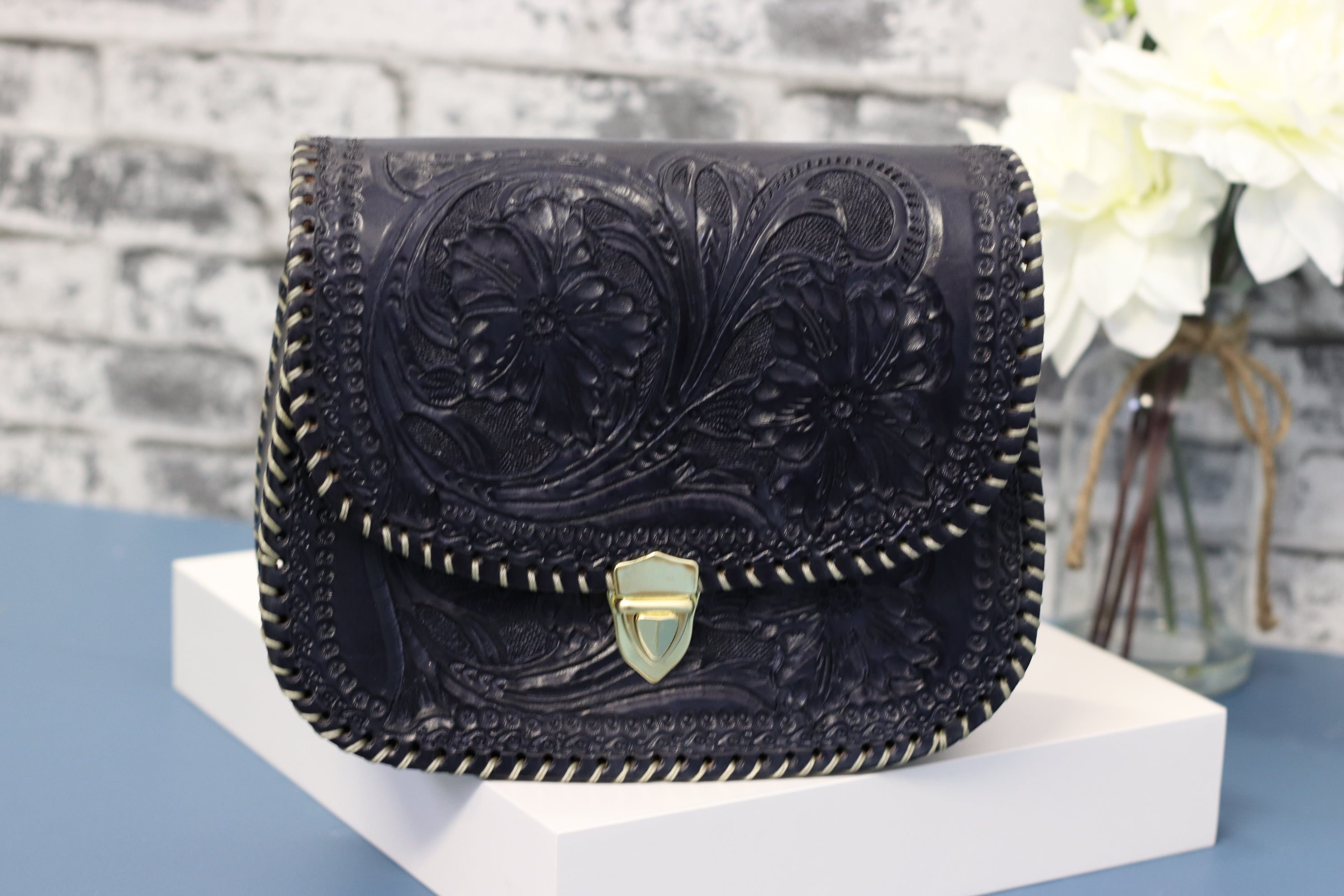 Blue leather clutch, hand-tooled leather with gold clasp closure. Clutch Handbag. Made by artisans in Central Mexico, shipping from the USA. Handmade. Buy now at www.felipeandgrace.com. 