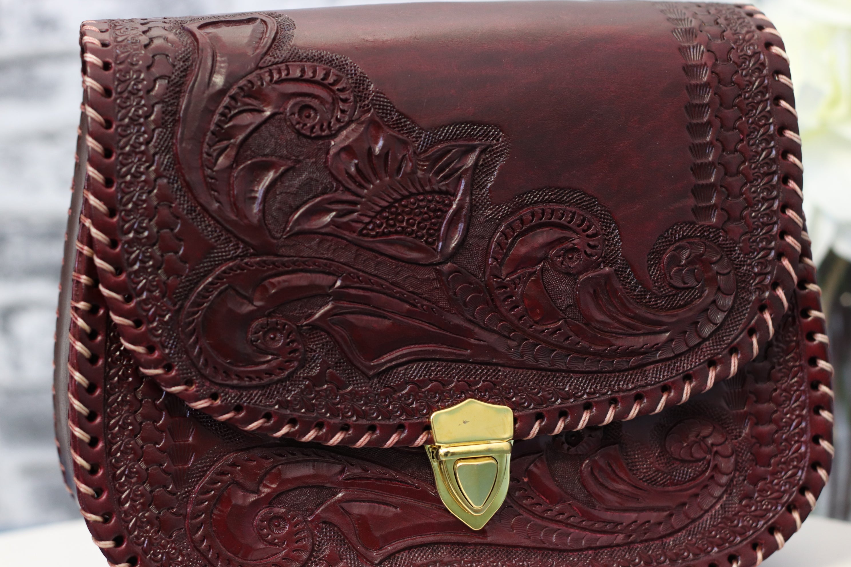 Wine color leather clutch,hand-tooled leather with gold clasp closure. Clutch Handbag. Made by artisans in Central Mexico, shipping from the USA. Handmade. Buy now at www.felipeandgrace.com. 