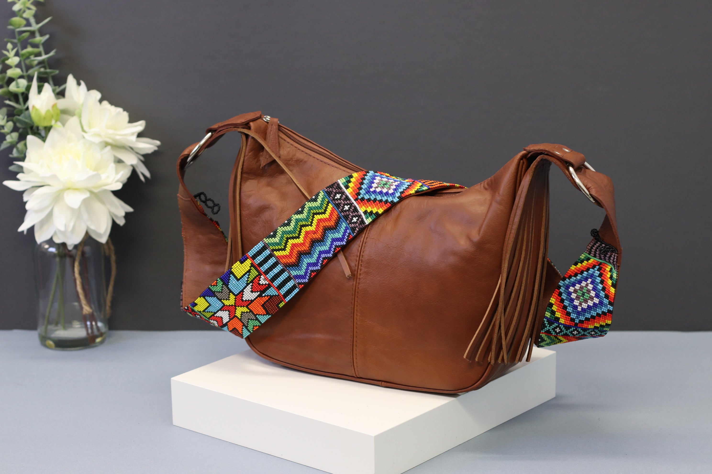 Brown Leather Messenger Bag with Hand Beaded Seed Bead Shoulder Strap. Handmade, Fast Shipping. Brown, Tan, with handles and a long strap. Cowhide Leather with Seed Bead Accent. Buy now at www.felipeandgrace.com