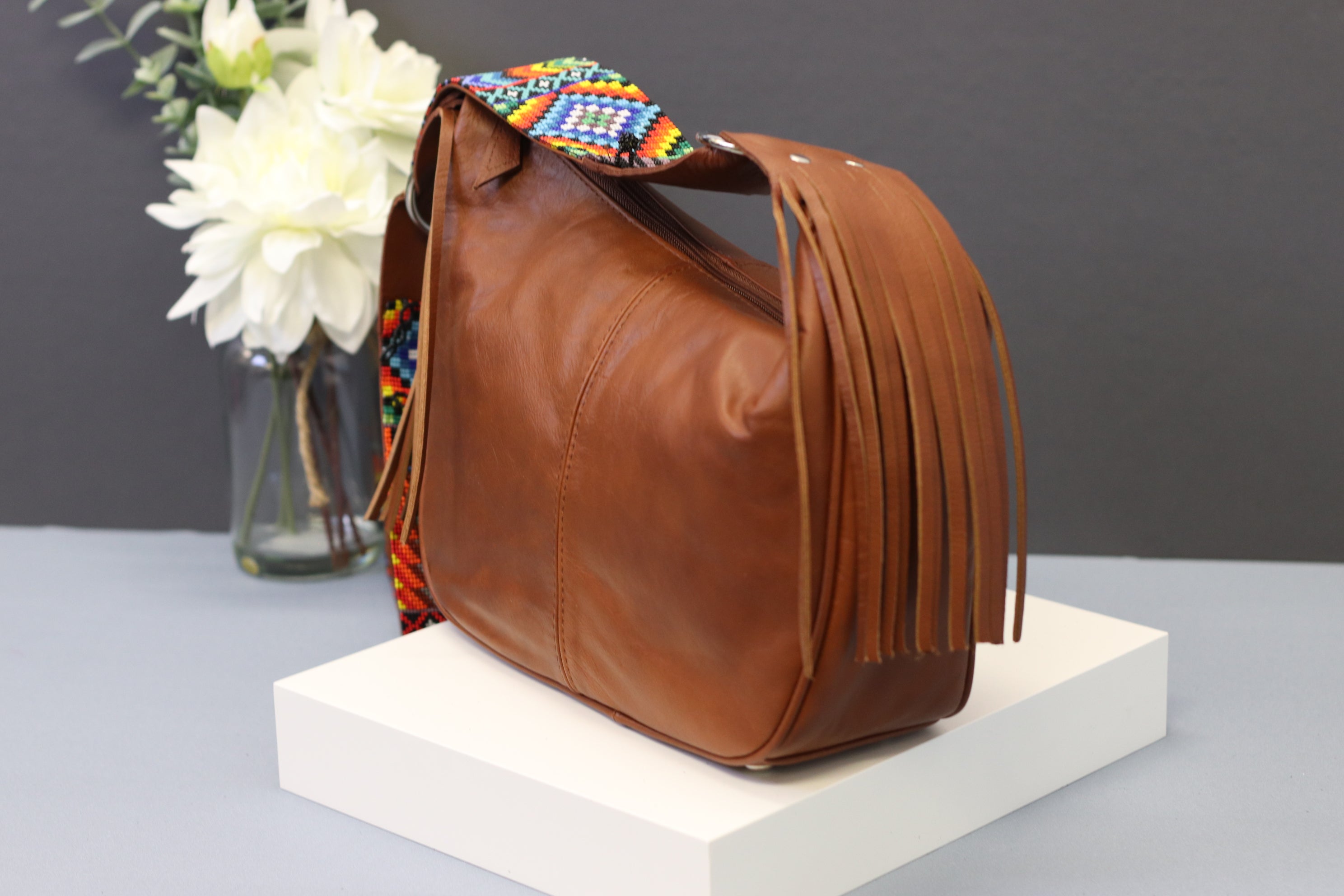 Brown Leather Messenger Bag with Hand Beaded Seed Bead Shoulder Strap. Handmade, Fast Shipping. Brown, Tan, with handles and a long strap. Cowhide Leather with Seed Bead Accent. Buy now at www.felipeandgrace.com