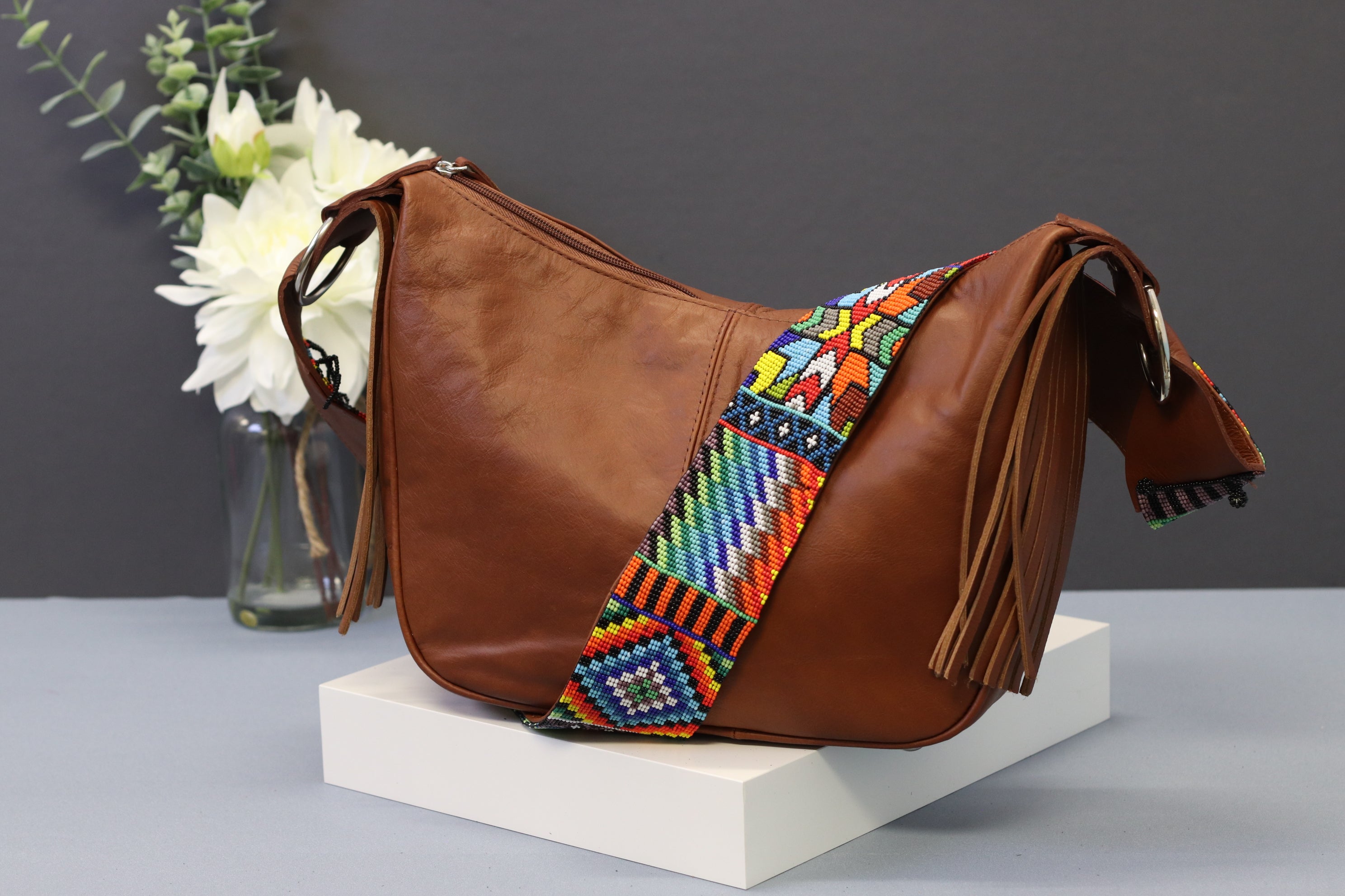 Brown Leather Messenger Bag with Hand Beaded Seed Bead Shoulder Strap. Handmade, Fast Shipping. Brown, Tan, with handles and a long strap. Cowhide Leather with Seed Bead Accent. Buy now at www.felipeandgrace.com