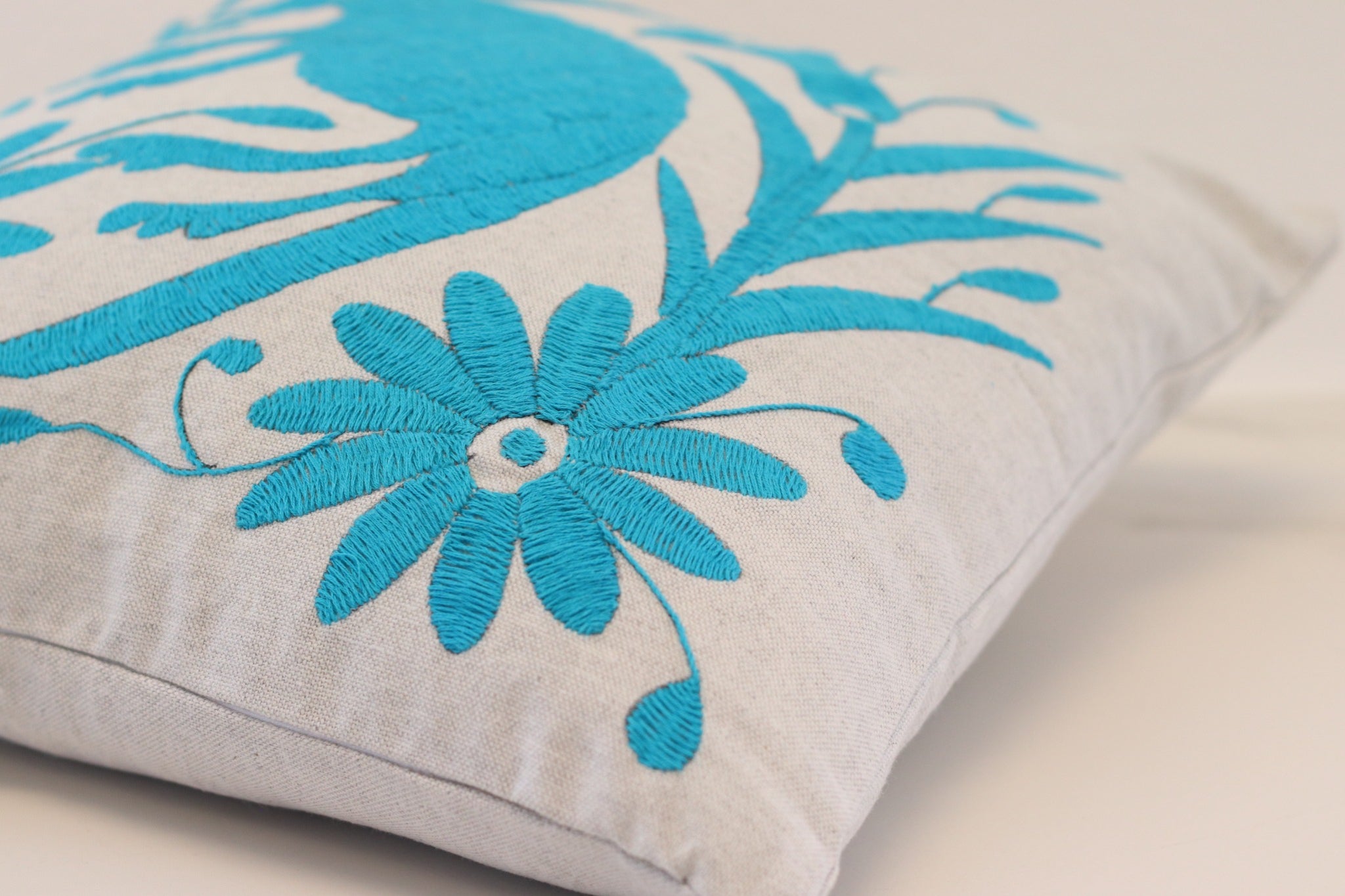  Aqua and Light Gray Square Otomi Tenango Pillow Cover with Hand Embroidered Birds, Flowers, and Animals in Vibrant Colors. Handmade in Mexico. Ships from the USA. Buy now at www.felipeandgrace.com.