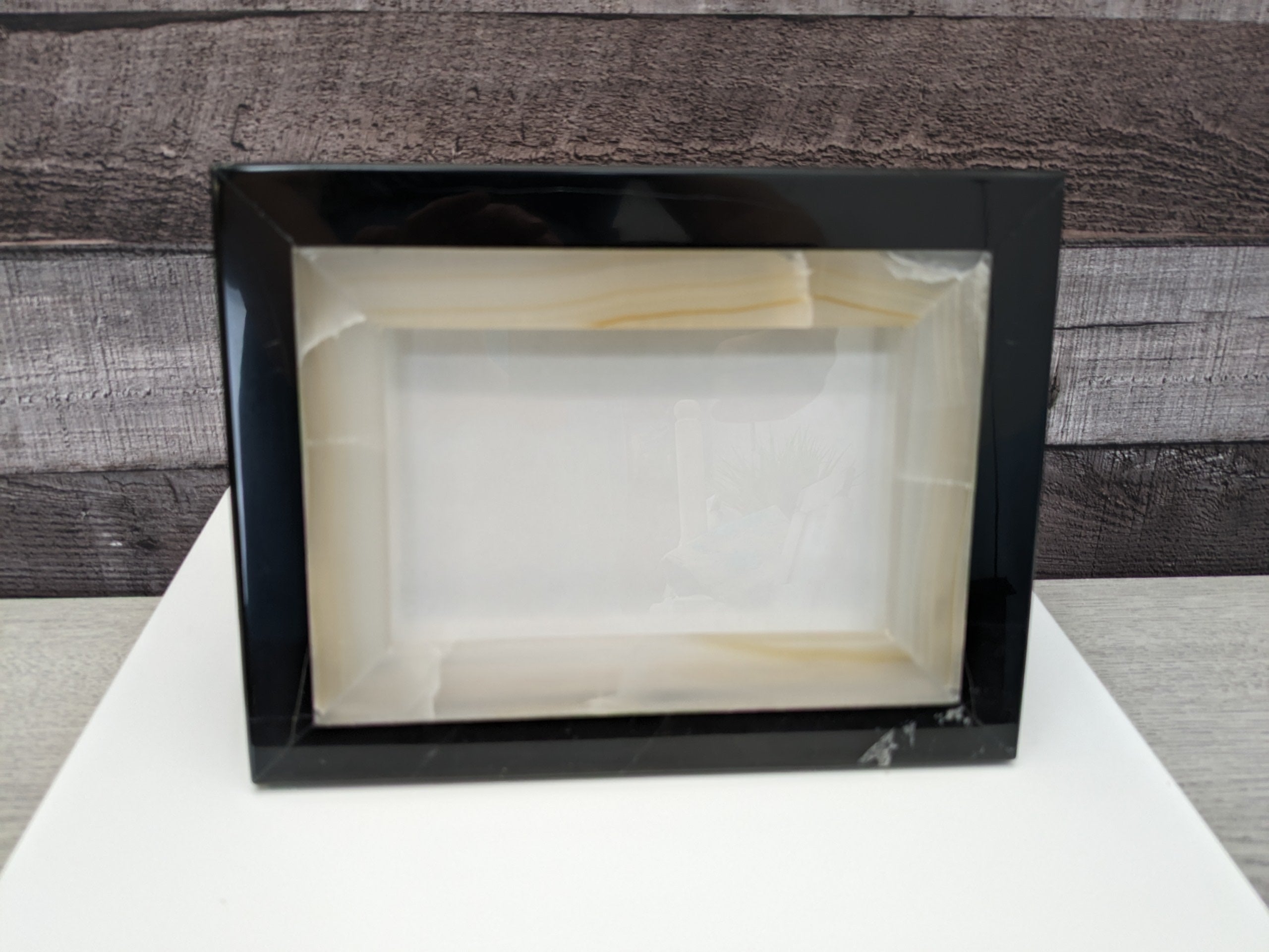 Black and White Onyx Frame with Glass Covering and a Travertine Stone Stand. Handmade in Mexico. We package and ship from the USA. Buy now at www.felipeandgrace.com.