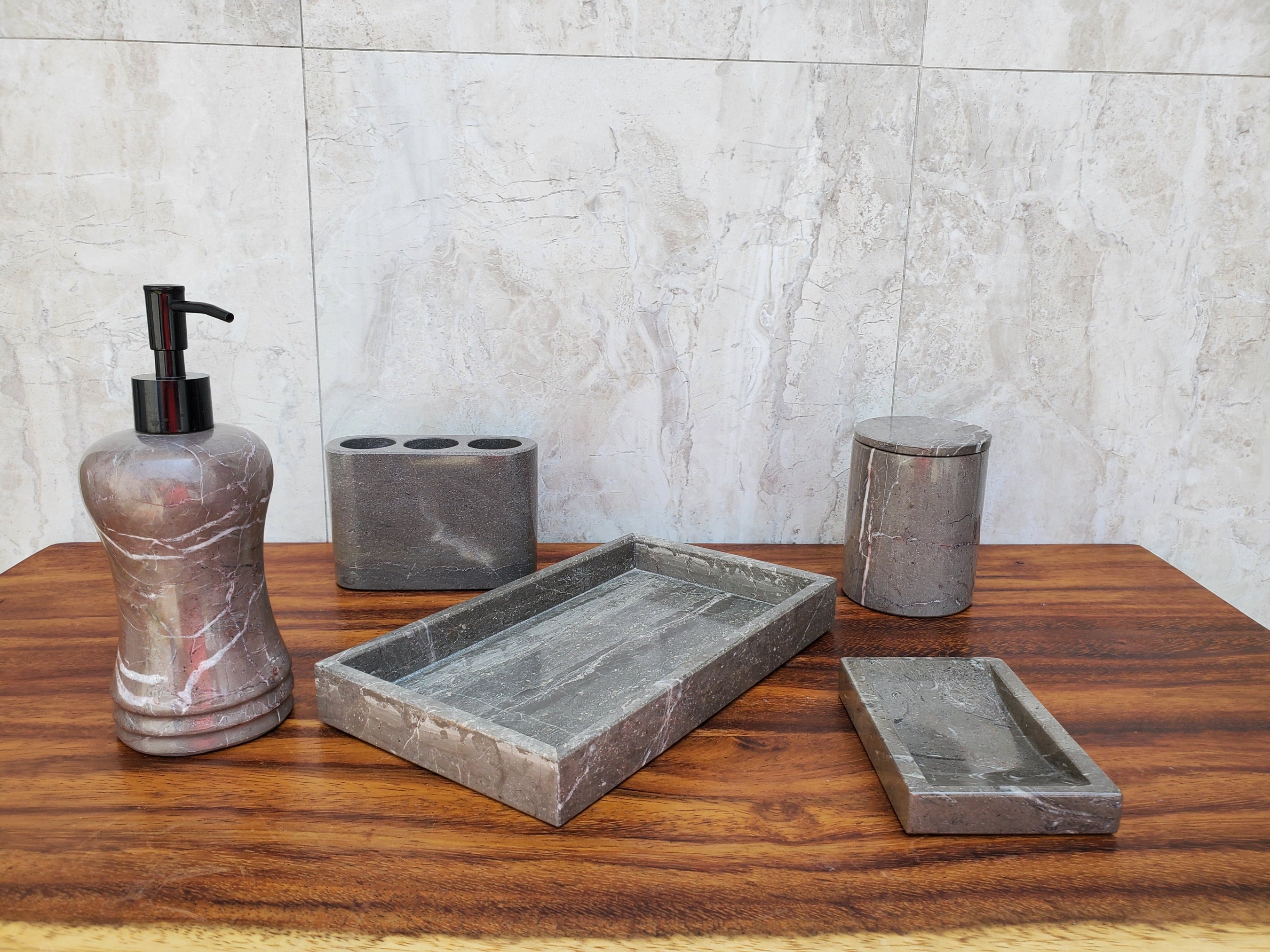 Gray and White Marble Bathroom Accessory Set. The set includes Lotion Dispenser, a Three Slot Toothbrush Holder, a Soap Dish, and a Tray. Handmade in Mexico. We package and ship from the USA. Buy now at www.felipeandgrace.com. 