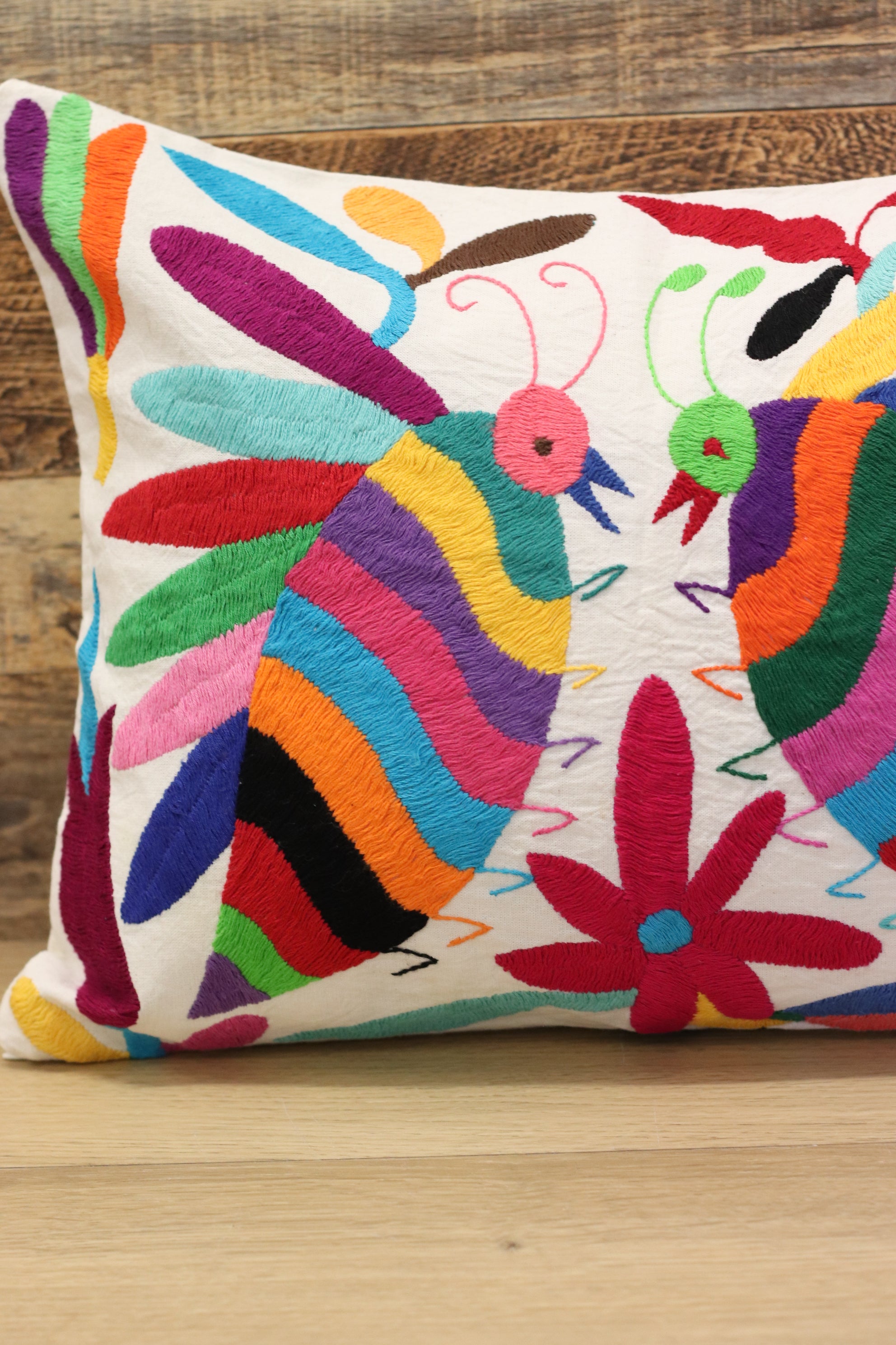 Otomi Tenango Pillow Cover Hand Embroidered with Cute Bugs and Flowers in Vibrant Colors. Handmade in Mexico. Ships from the USA. Buy now at www.felipeandgrace.com. 