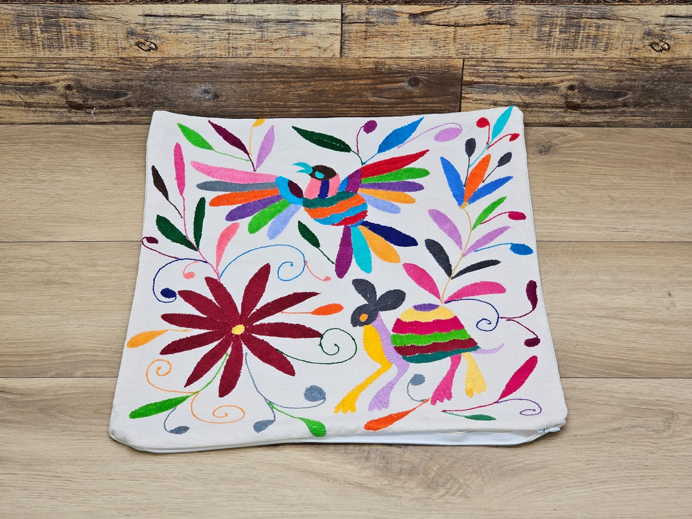 Square Otomi Tenango Pillow Cover with Hand Embroidered Turtle, Bird, and Flower Design in Vibrant Colors. Handmade in Mexico. Ships from the USA. Buy now at www.felipeandgrace.com.