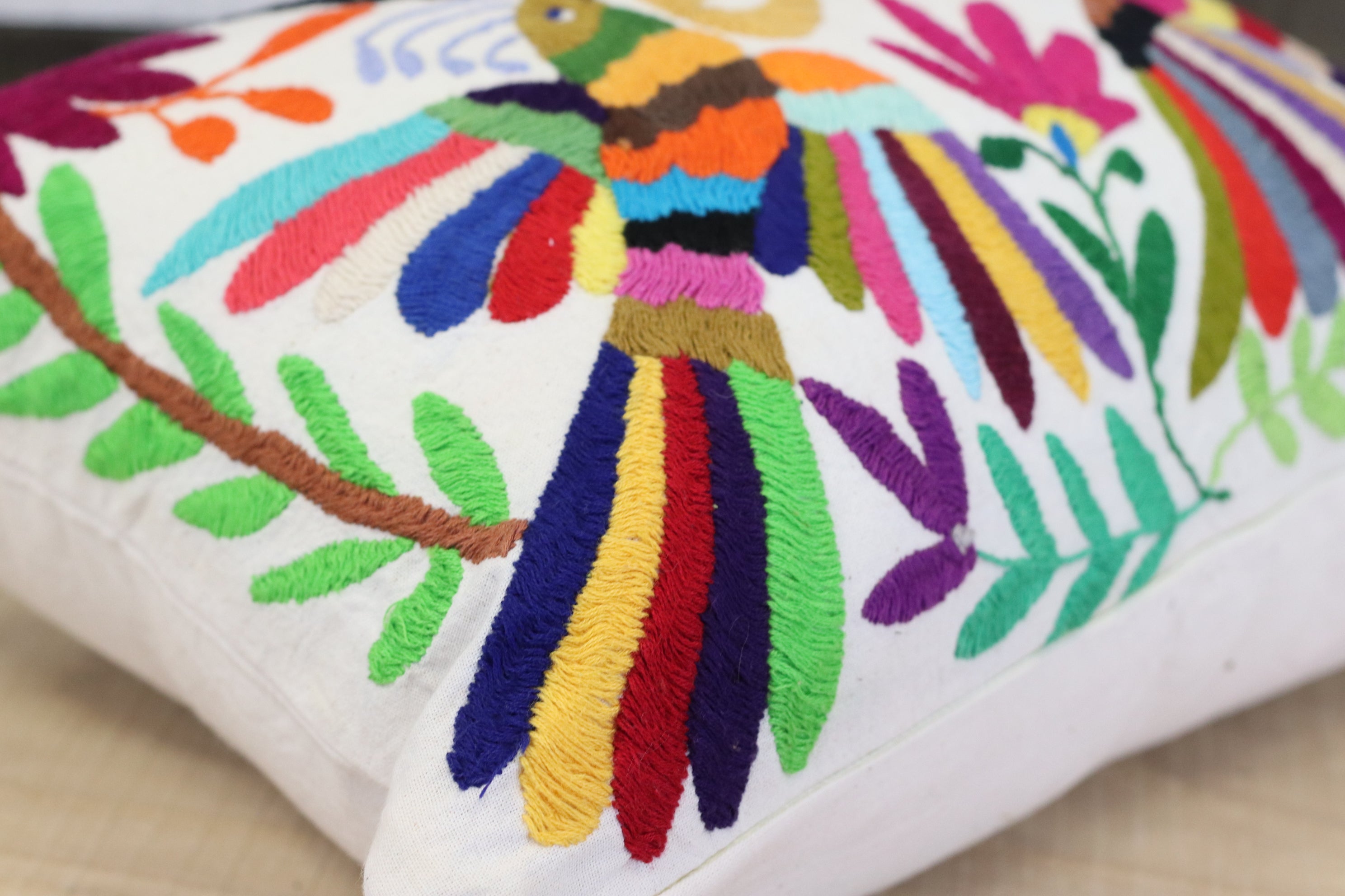 Rectangle Otomi Tenango Pillow Cover with Hand Embroidered Butterfly, Bird and Flower Design in Vibrant Colors. Handmade in Mexico. Ships from the USA. Buy now at www.felipeandgrace.com.