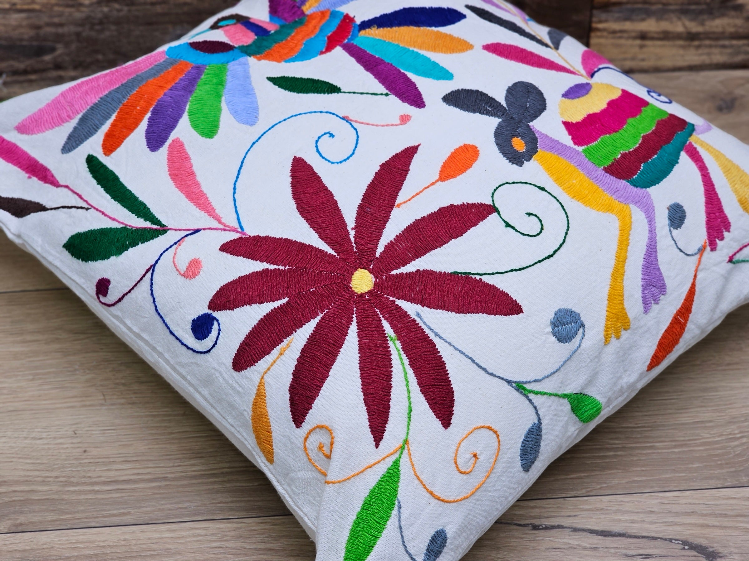 Square Otomi Tenango Pillow Cover with Hand Embroidered Turtle, Bird, and Flower Design in Vibrant Colors. Handmade in Mexico. Ships from the USA. Buy now at www.felipeandgrace.com.
