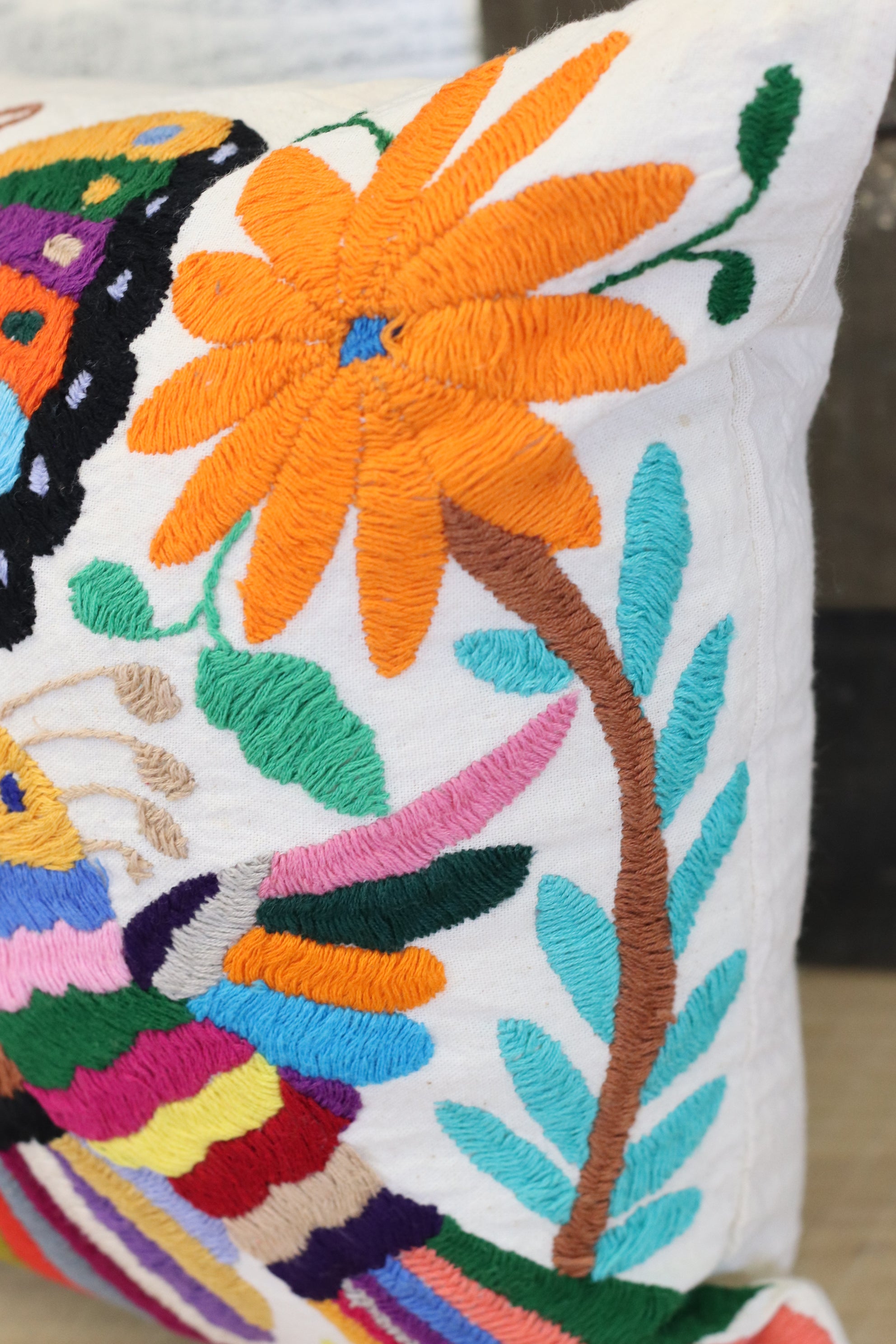 Rectangle Otomi Tenango Pillow Cover with Hand Embroidered Butterfly, Bird and Flower Design in Vibrant Colors. Handmade in Mexico. Ships from the USA. Buy now at www.felipeandgrace.com.