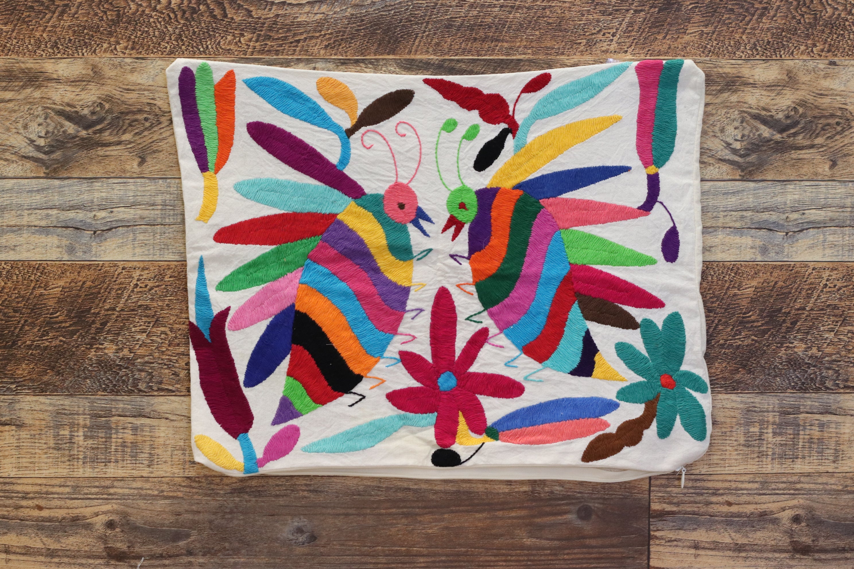 Otomi Tenango Pillow Cover Hand Embroidered with Cute Bugs and Flowers in Vibrant Colors. Handmade in Mexico. Ships from the USA. Buy now at www.felipeandgrace.com. 