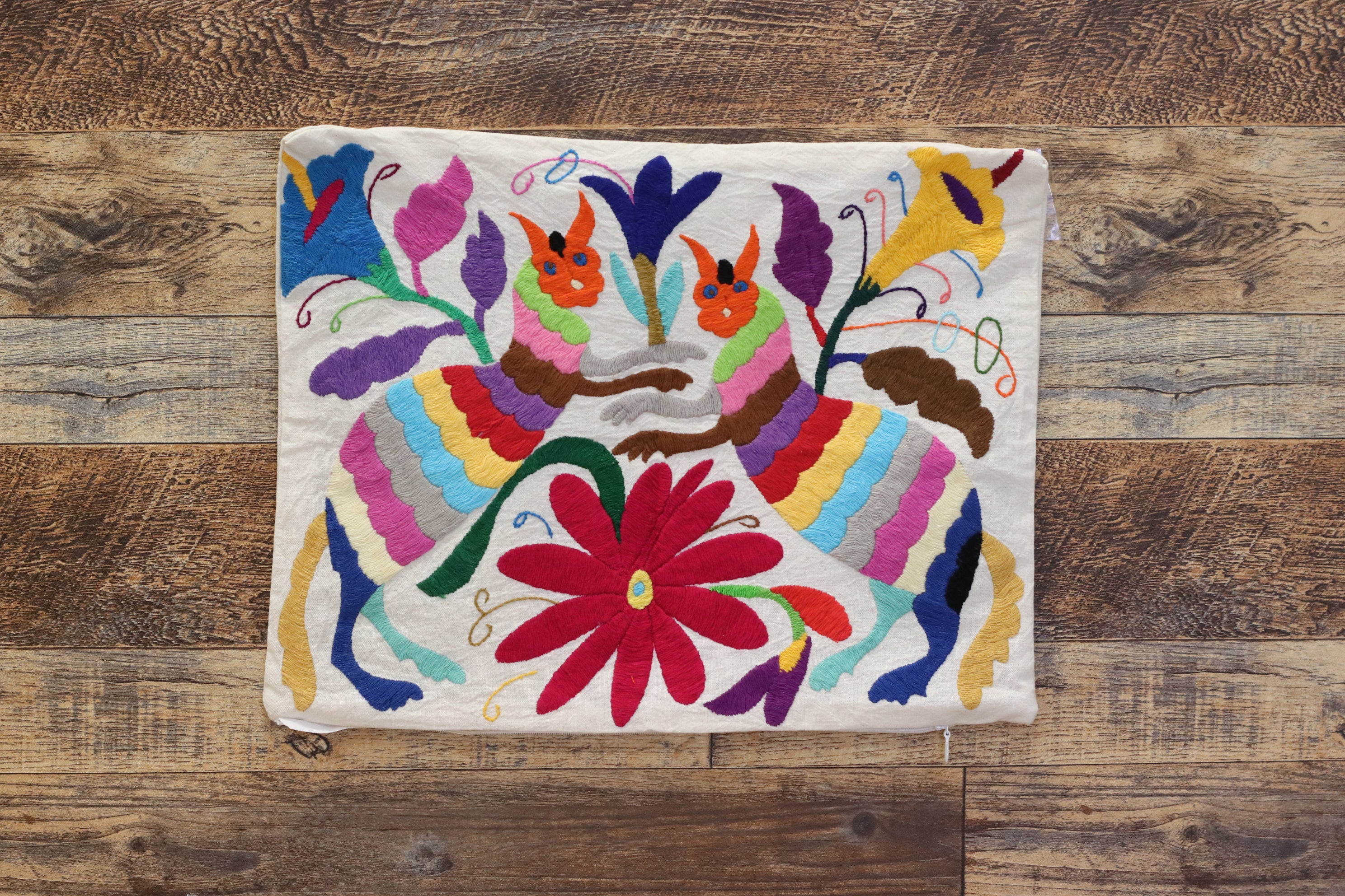Otomi Tenango Pillow Cover Hand Embroidered with Flowers and Animals in Vibrant Colors. Handmade in Mexico. Ships from the USA. Buy now at www.felipeandgrace.com. 