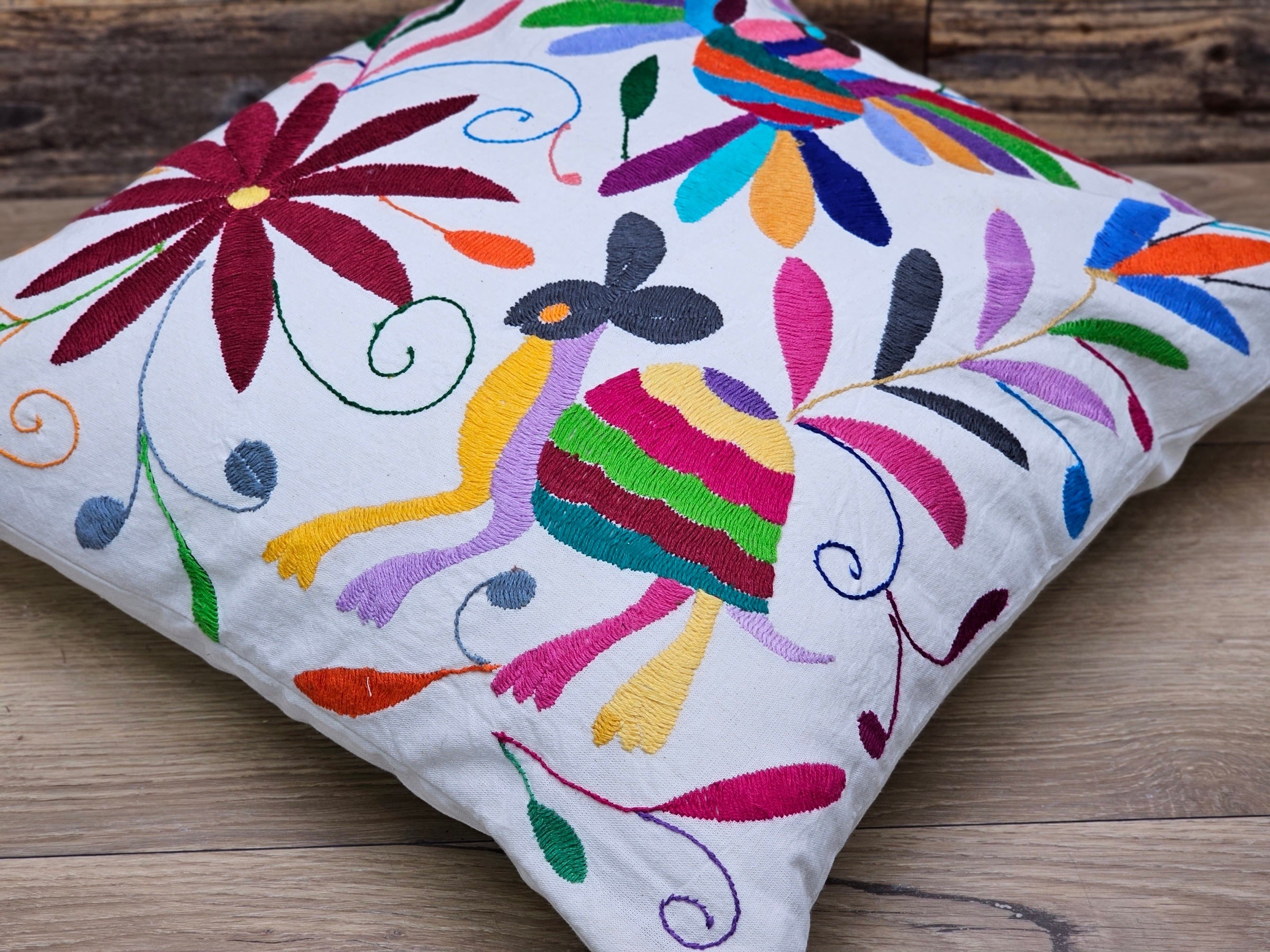 Square Otomi Tenango Pillow Cover with Hand Embroidered Turtle, Bird, and Flower Design in Vibrant Colors. Handmade in Mexico. Ships from the USA. Buy now at www.felipeandgrace.com.