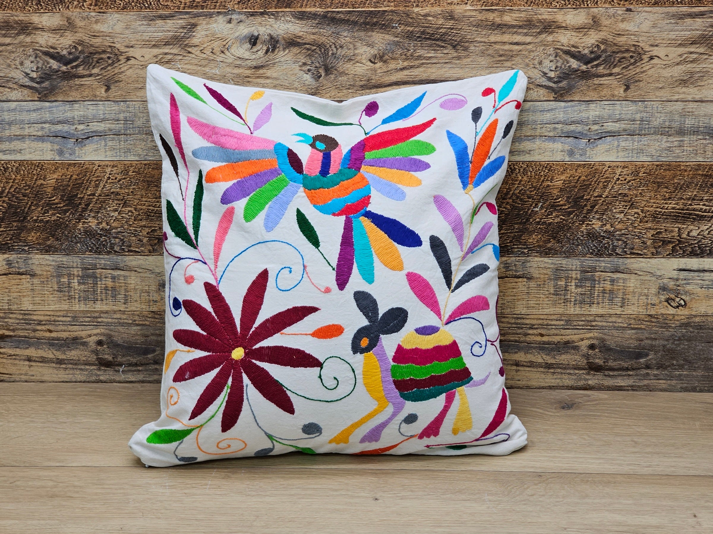 Square Otomi Tenango Pillow Cover with Hand Embroidered Turtle, Bird, and Flower Design in Vibrant Colors. Handmade in Mexico. Ships from the USA. Buy now at www.felipeandgrace.com.