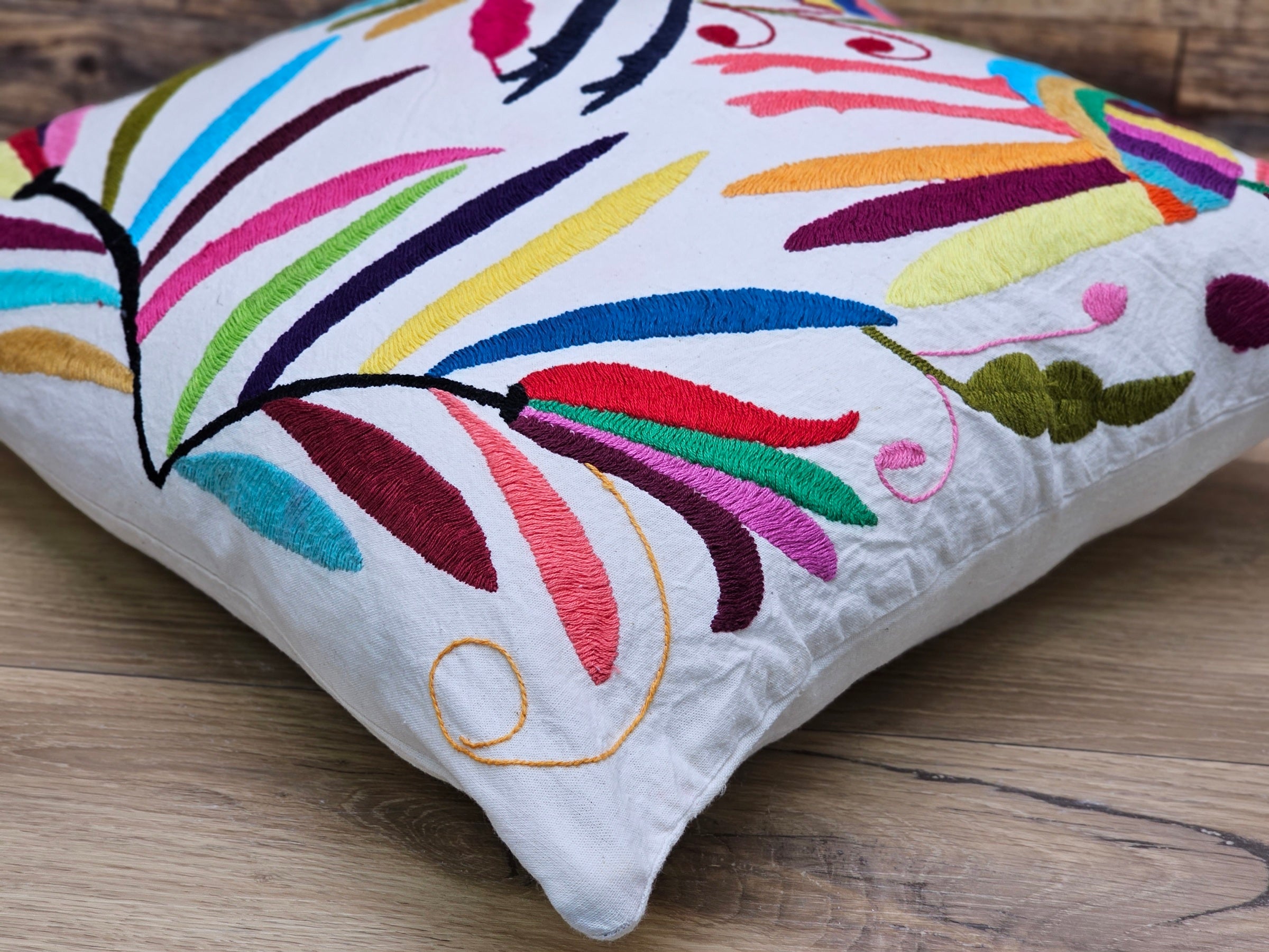 Square Otomi Tenango Pillow Cover with Hand Embroidered Birds and Plants in Vibrant Colors. Handmade in Mexico. Ships from the USA. Buy now at www.felipeandgrace.com.