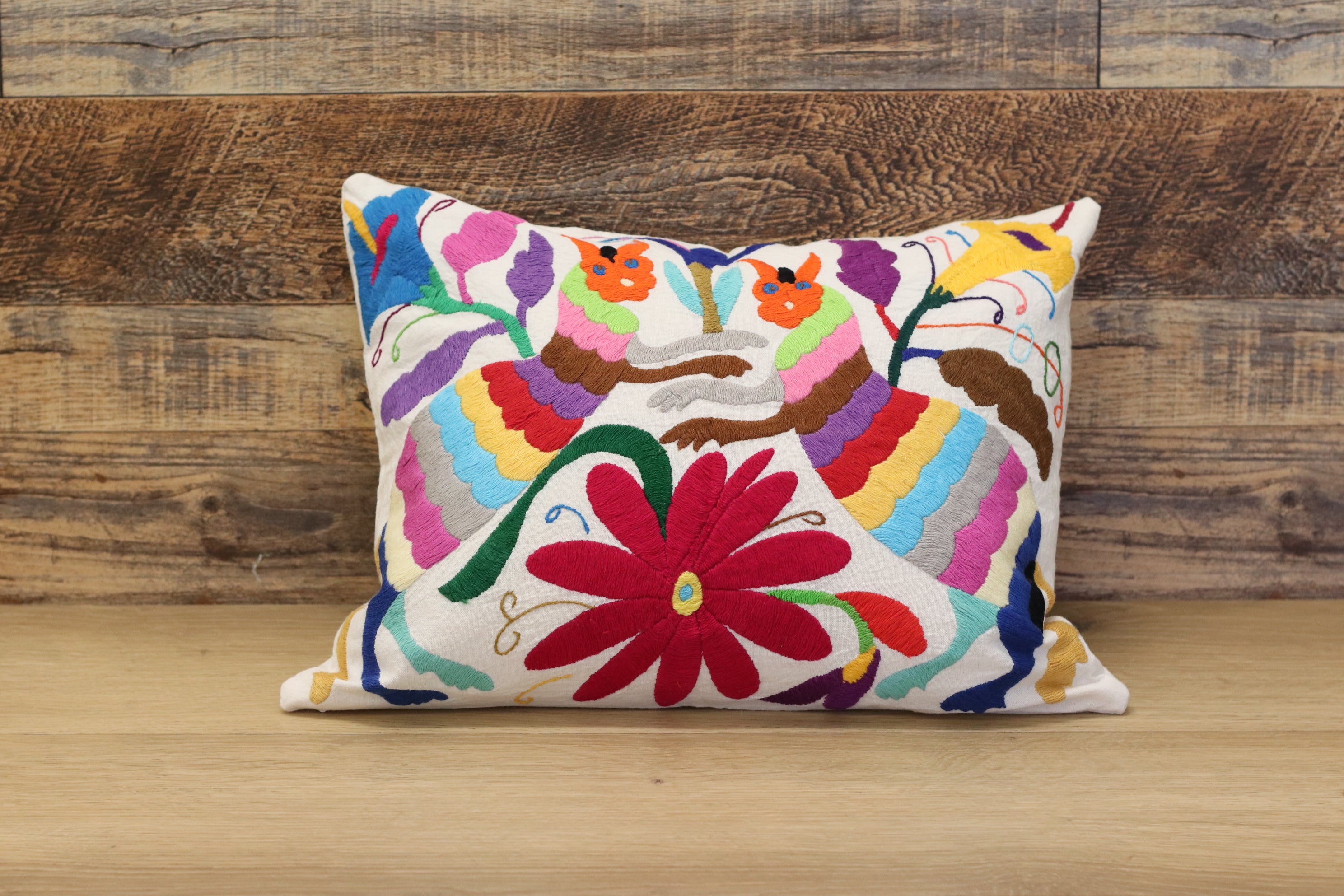 Otomi Tenango Pillow Cover Hand Embroidered with Flowers and Animals in Vibrant Colors. Handmade in Mexico. Ships from the USA. Buy now at www.felipeandgrace.com. 