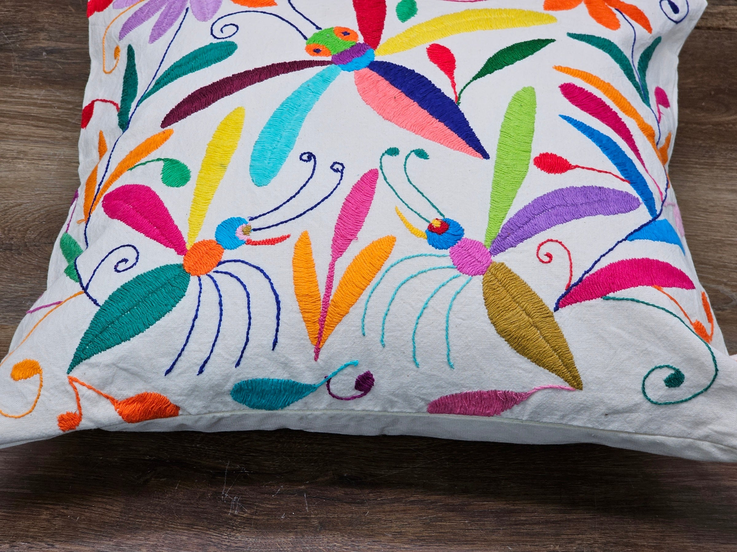 Square Otomi Tenango Pillow Cover with Hand Embroidered Dragonfly and Flower Design in Vibrant Colors. Handmade in Mexico. Ships from the USA. Buy now at www.felipeandgrace.com.