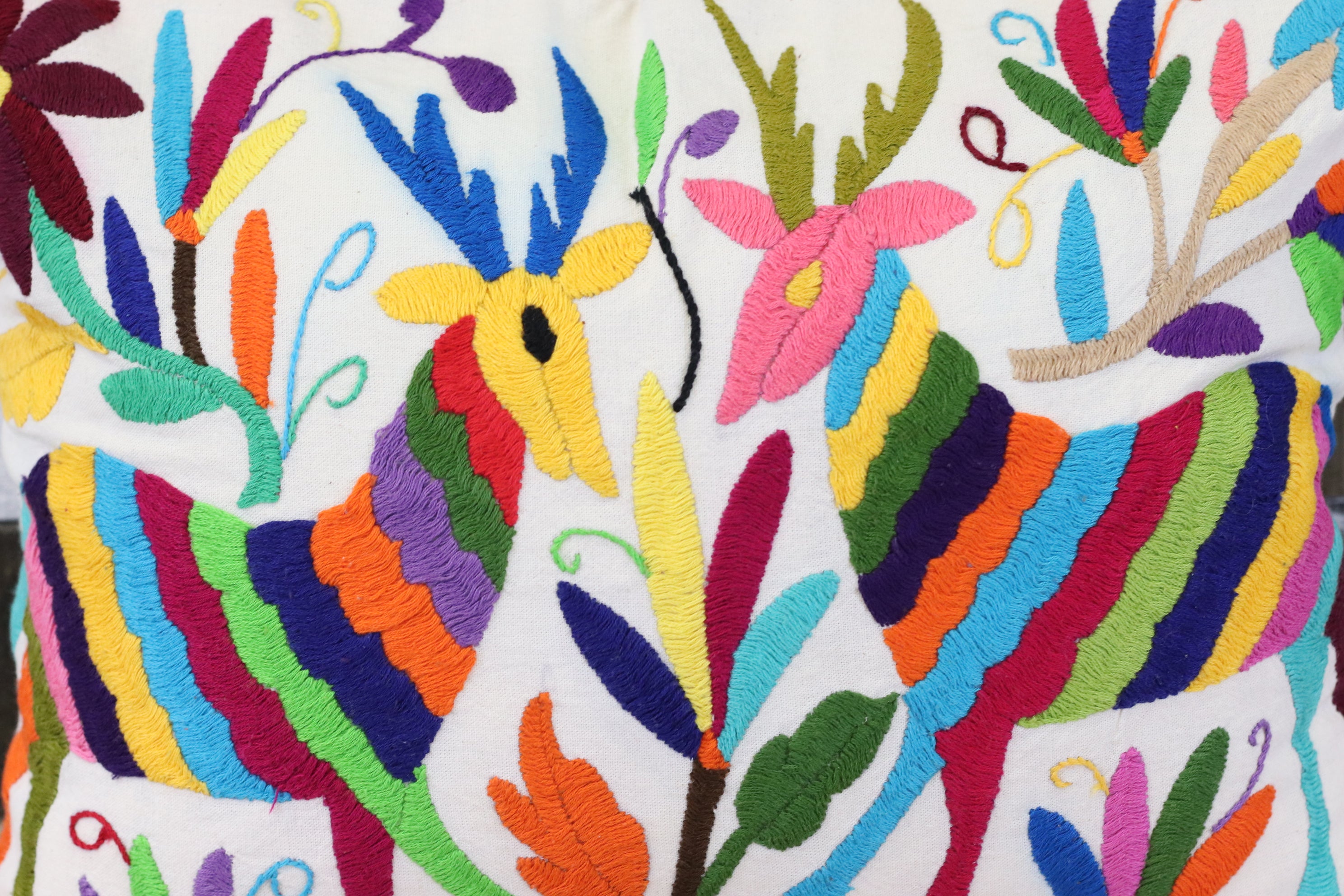 Otomi Tenango Pillow Cover Hand Embroidered with Flowers and Animals in Vibrant Colors. Handmade in Mexico. Ships from the USA. Buy now at www.felipeandgrace.com. 
