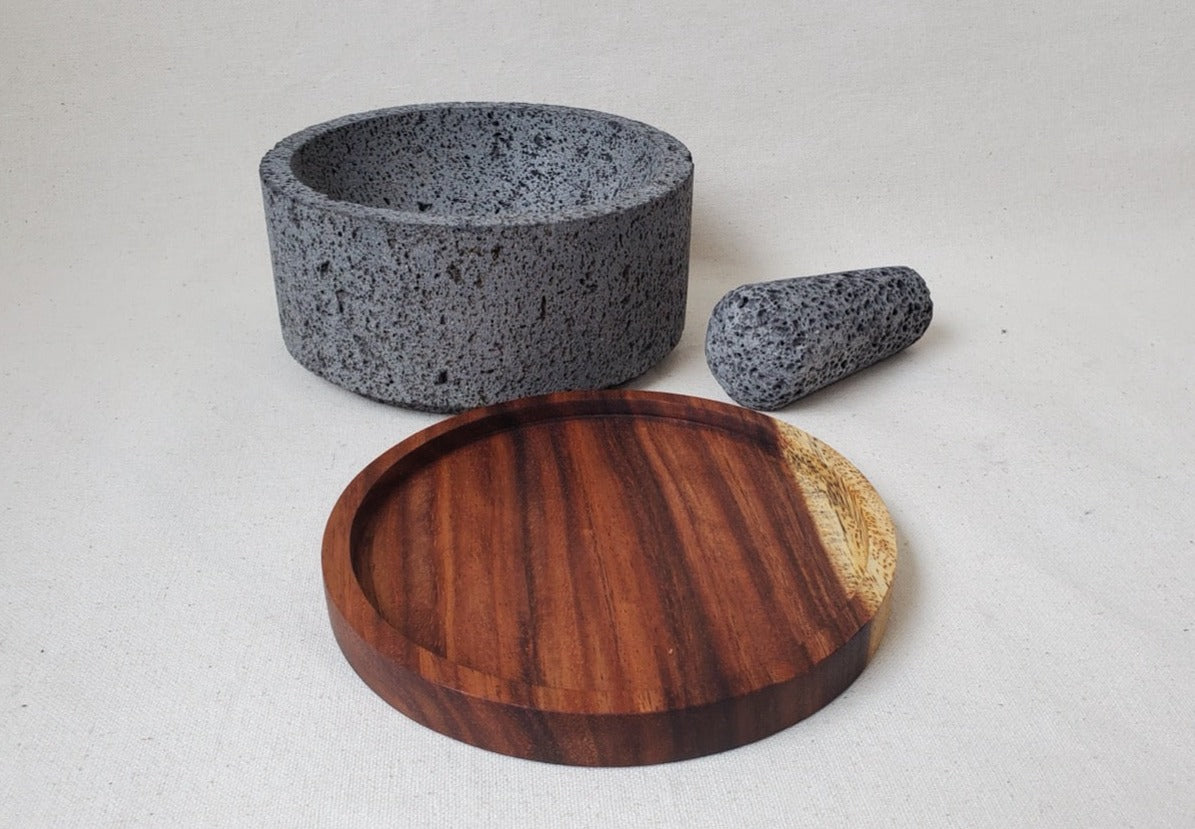 Authentic 8-inch Molcajete with a Wooden Base Pestle and Mortar Set. Made of pure basalt volcanic lava rock. Handmade in Mexico using traditional techniques. We hand finish, package, and ship from the USA. Buy now at www.felipeandgrace.com.