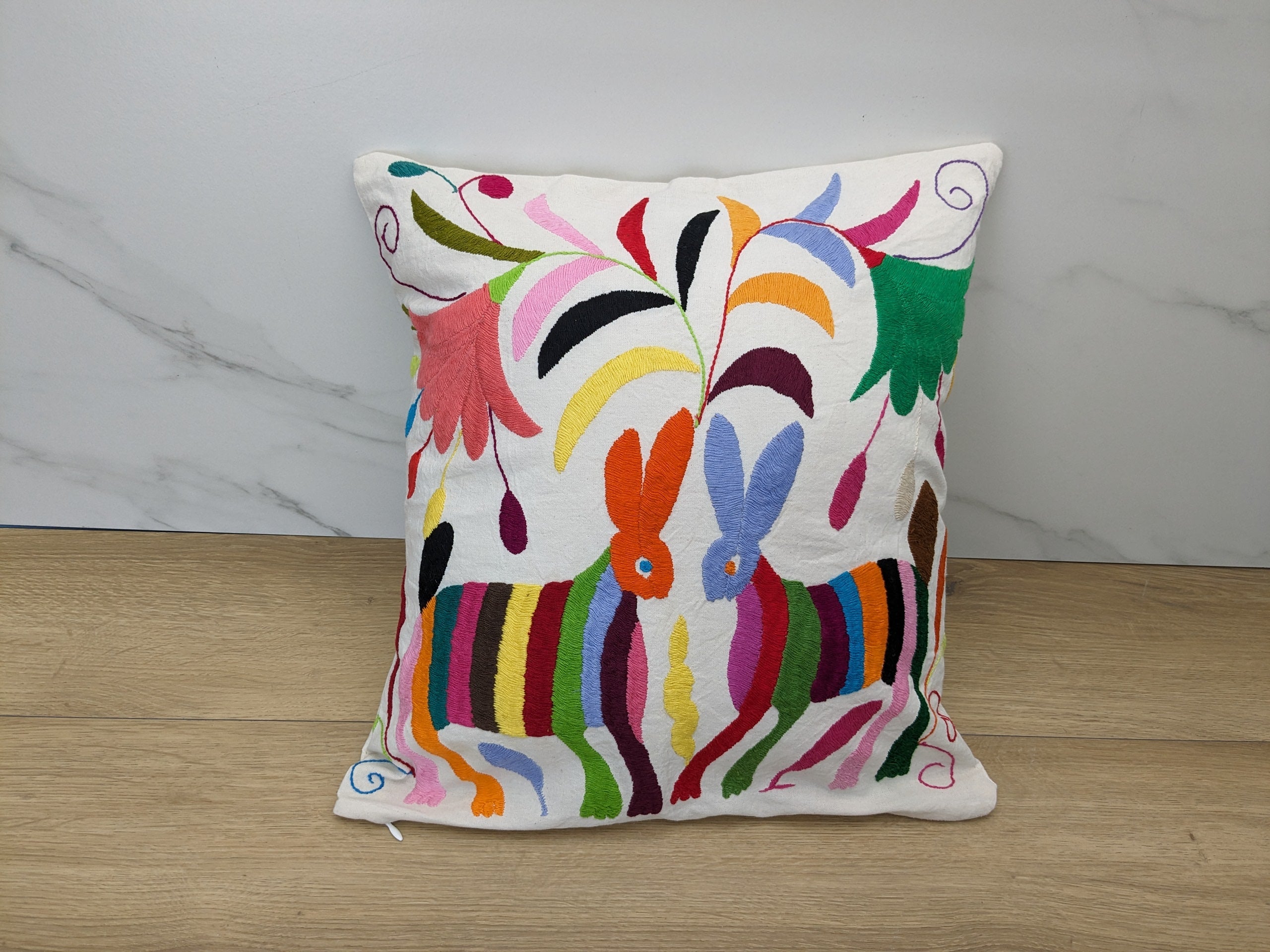 Multicolor Mexican Embroidered Throw Pillow Cover with Animals and Flowers. Handmade in Mexico. We package and ship from the USA. Buy now at www.felipeandgrace.com.