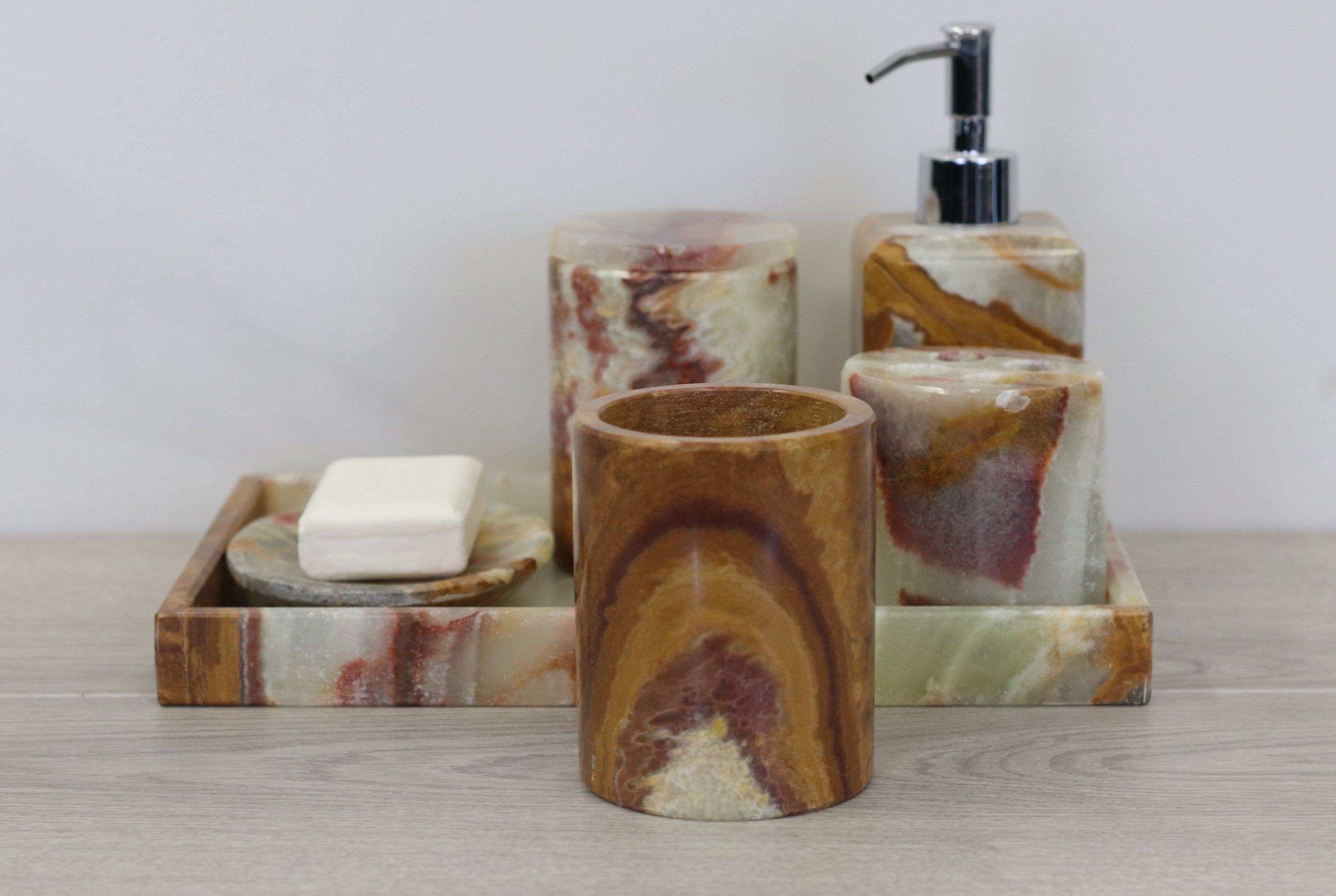 Green, Brown, and Red Onyx Stone Bathroom Accessory Set. This set includes a lotion dispenser, toothbrush holder, cup, tray, storage jar, and a soap dish. Handmade in Mexico. We package and ship from the USA. Buy now at www.felipeandgrace.com.