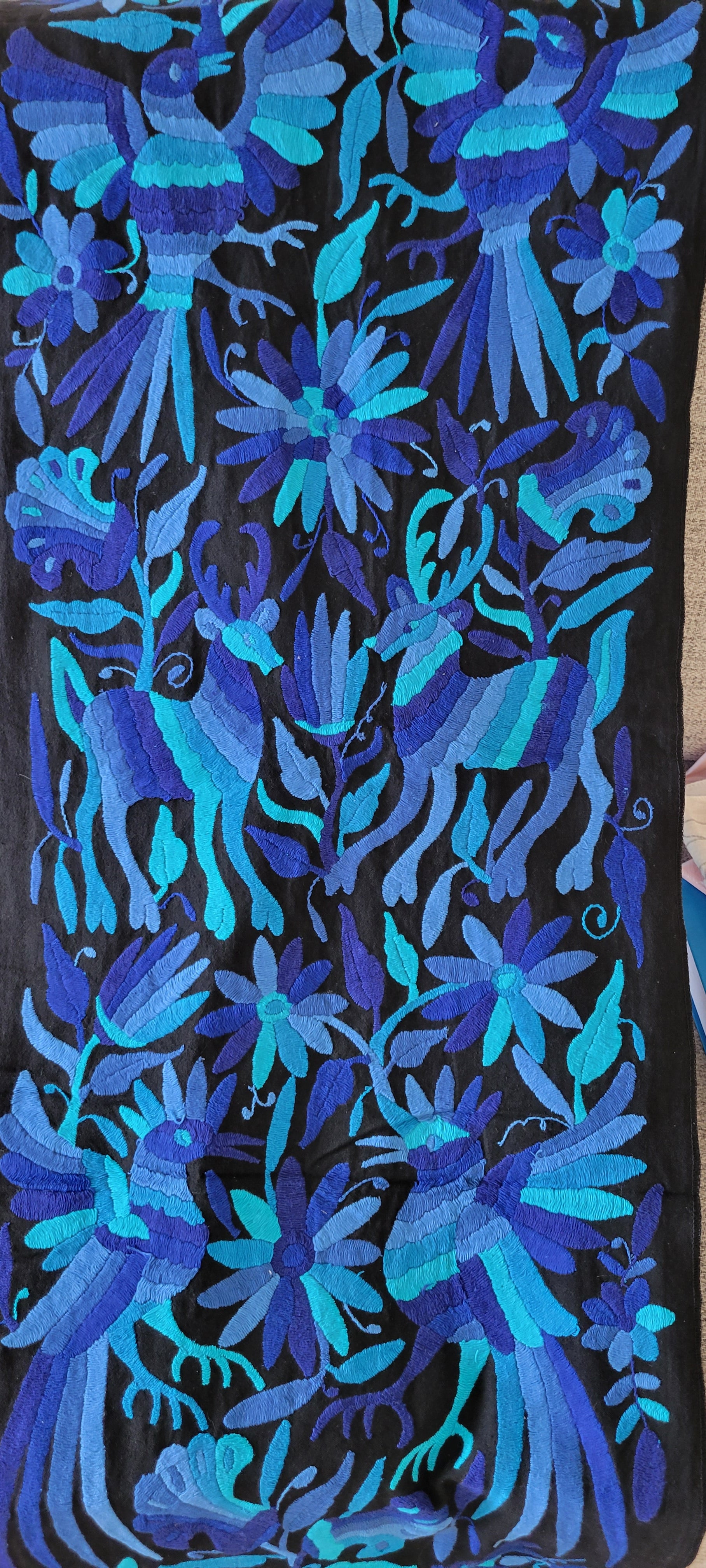 Blue Mexican Embroidery on Black Linen Background of Flowers, Animals, and Birds. Handmade in Mexico. We package and ship from the USA. Buy now at www.felipeandgrace.com.