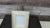 White Onyx Frame with Glass Covering and  Travertine Stone Stand. Handmade in Mexico. We package and ship from the USA. Buy now at www.felipeandgrace.com.