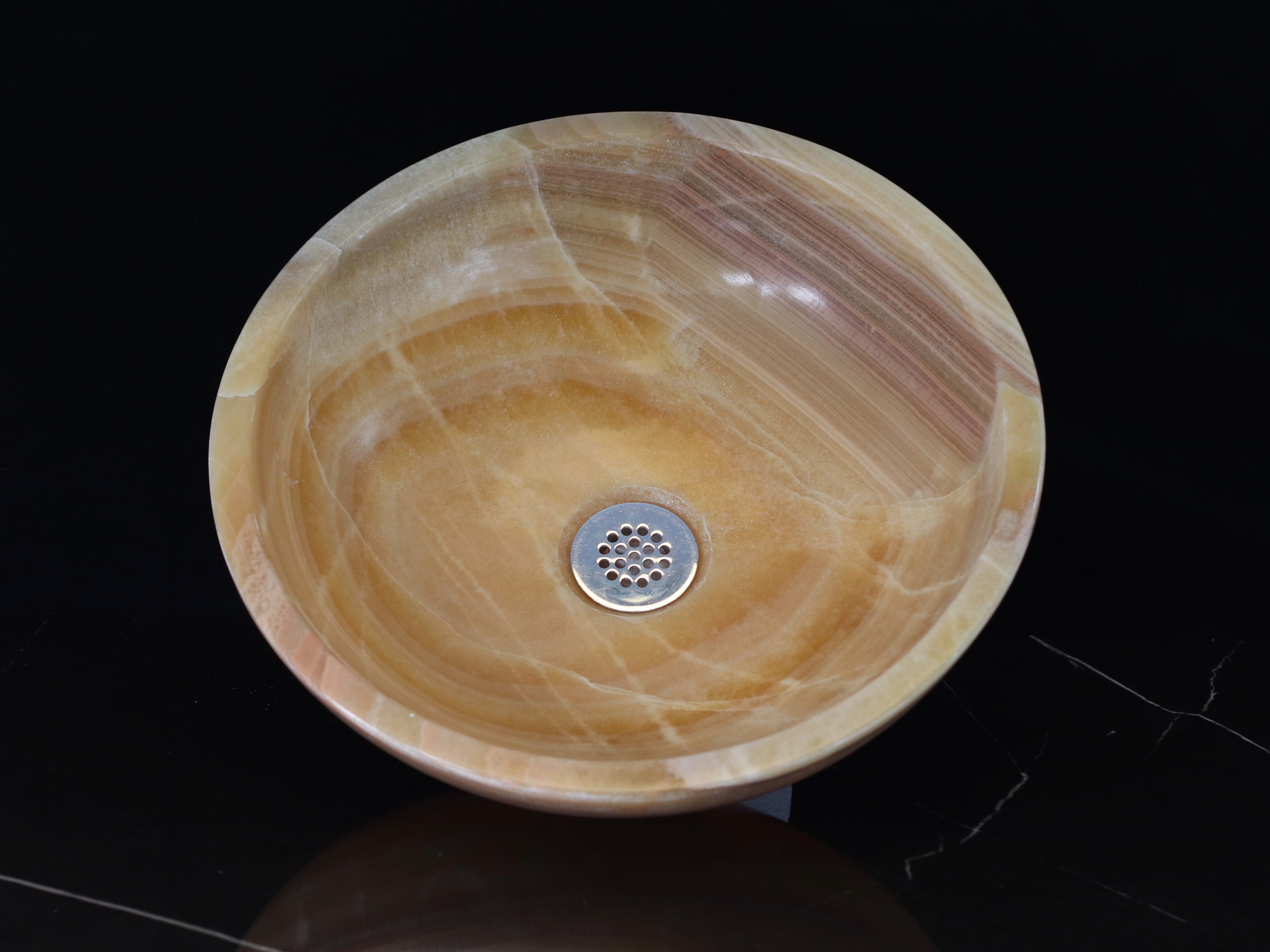 Brown and Tan Round Onyx Stone Vessel Sink. This sink is made to sit above the counter. It has a polished finish. Handmade in Mexico. We hand finish, package, and ship from the USA. Buy now at www.felipeandgrace.com. 