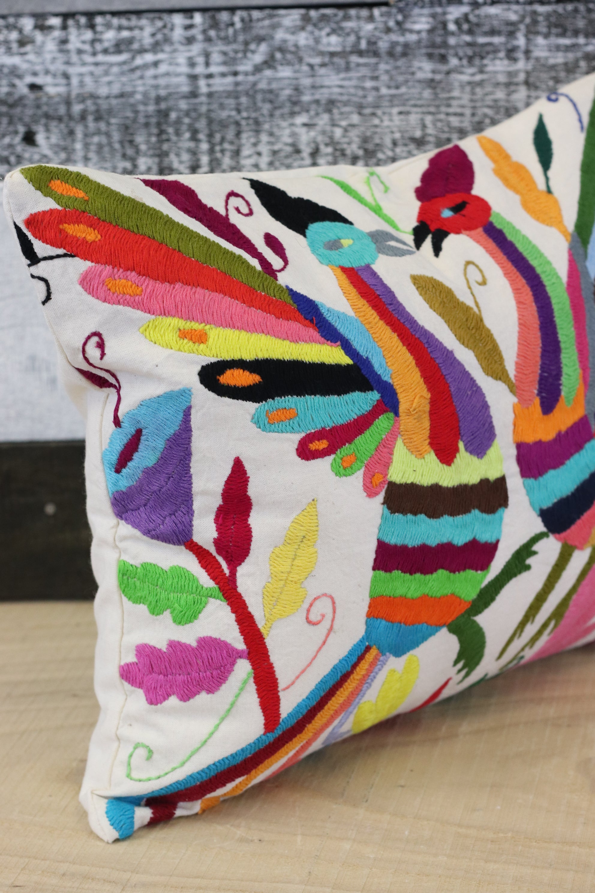 Rectangle Otomi Tenango Pillow Cover with Hand Embroidered Birds, Flowers, and Animals in Vibrant Colors. Handmade in Mexico. Ships from the USA. Buy now at www.felipeandgrace.com.