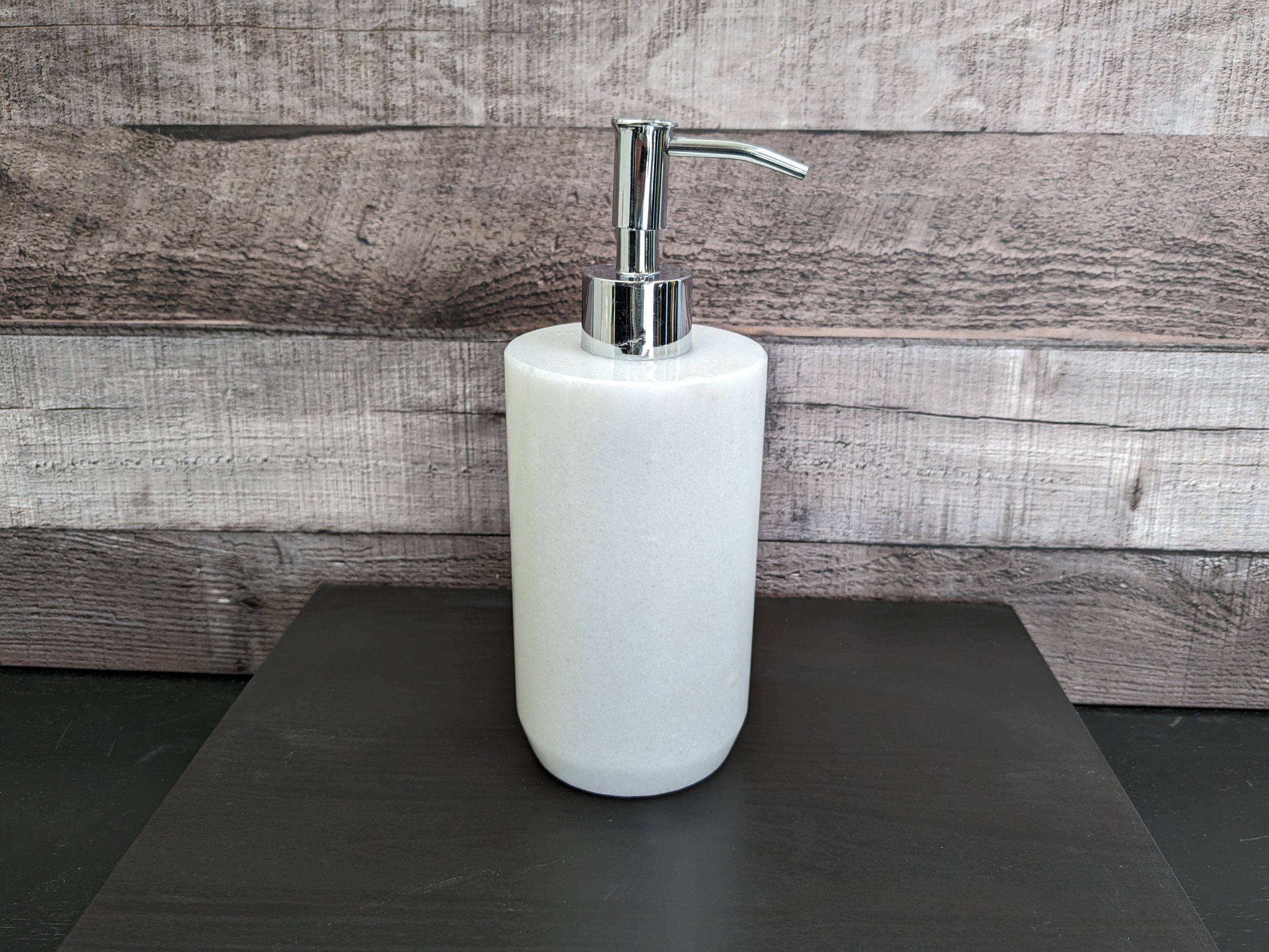 White Onyx Stone Soap and Lotion Dispenser. It has a cylindrical shape. Handmade in Mexico. Ships from the USA. Buy now at www.felipeandgrace.com.