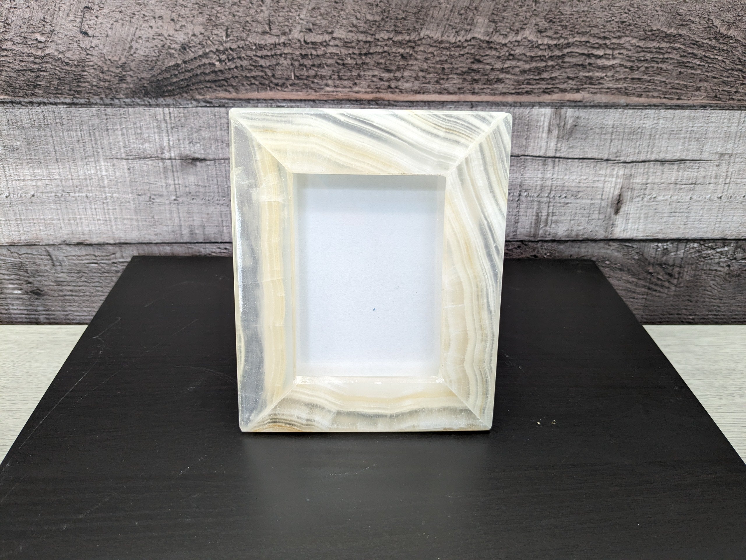 White Onyx Frame with Glass Covering and  Travertine Stone Stand. Handmade in Mexico. We package and ship from the USA. Buy now at www.felipeandgrace.com.