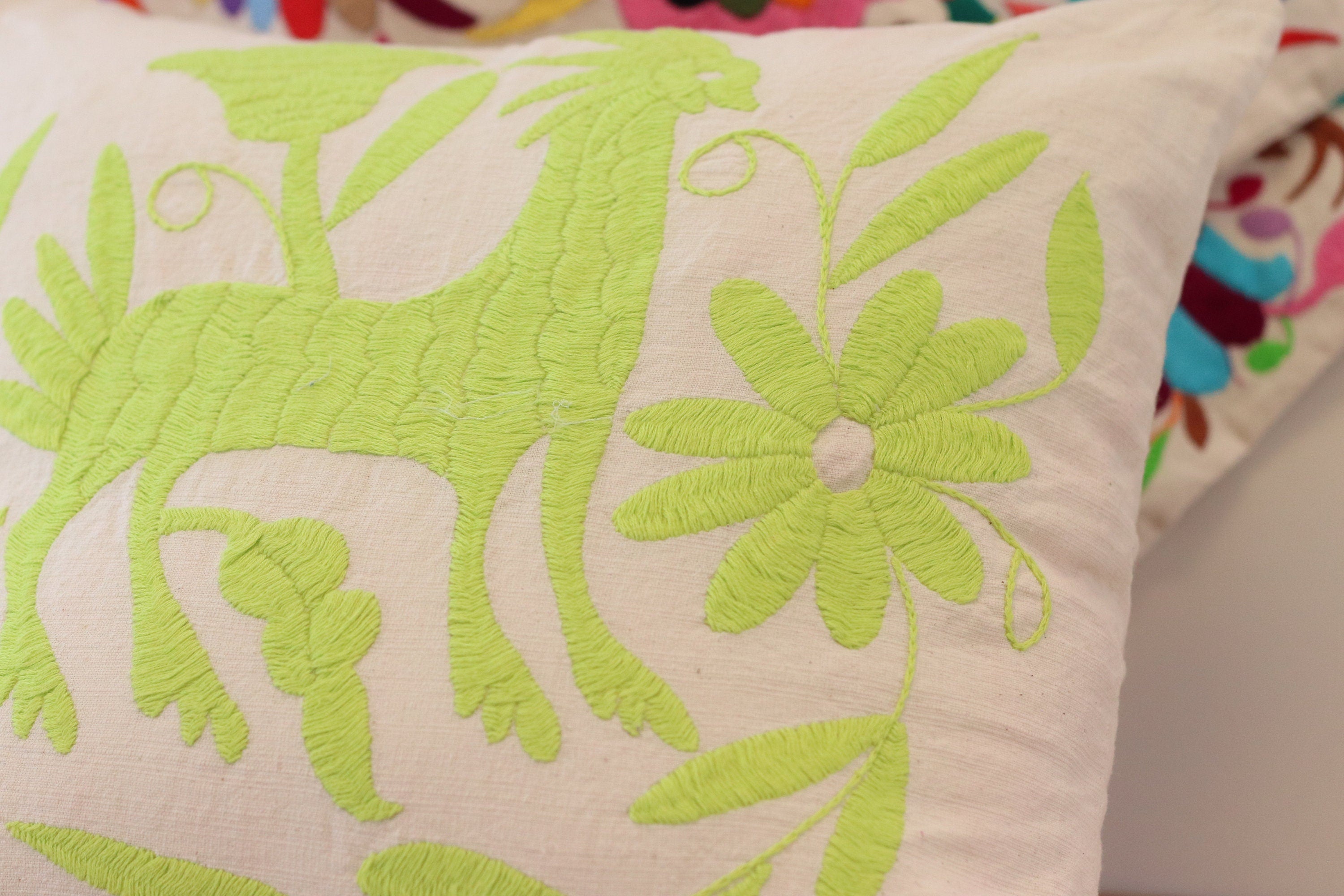 Bright Green Flower and Animal Hand Embroidered Pillow Cover on White Background. Handmade in Mexico. Ships from the USA. Buy now at www.felipeandgrace.com.